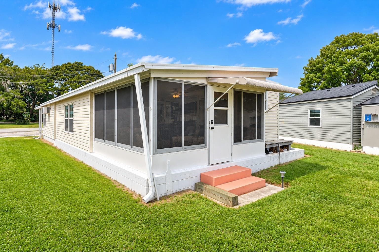 Back Exterior shows sunroom - 1405 WESTLAND DR, TAVARES