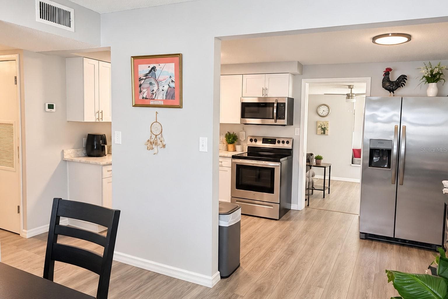 Stainless-steel appliances and generous workspace complete the updated kitchen. - 8514 93RD AVE, SEMINOLE