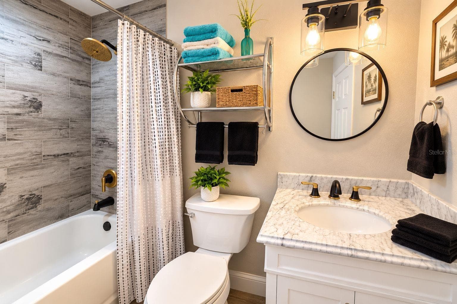 Remodeled bathroom accented by stylish black-and-gold fixtures. - 8514 93RD AVE, SEMINOLE