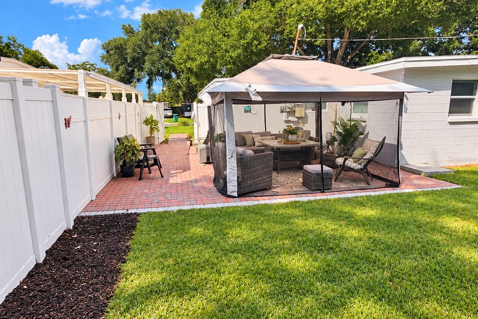 Shaded patio and canopy create a comfortable spot for morning coffee or evening relaxation. - 8514 93RD AVE, SEMINOLE