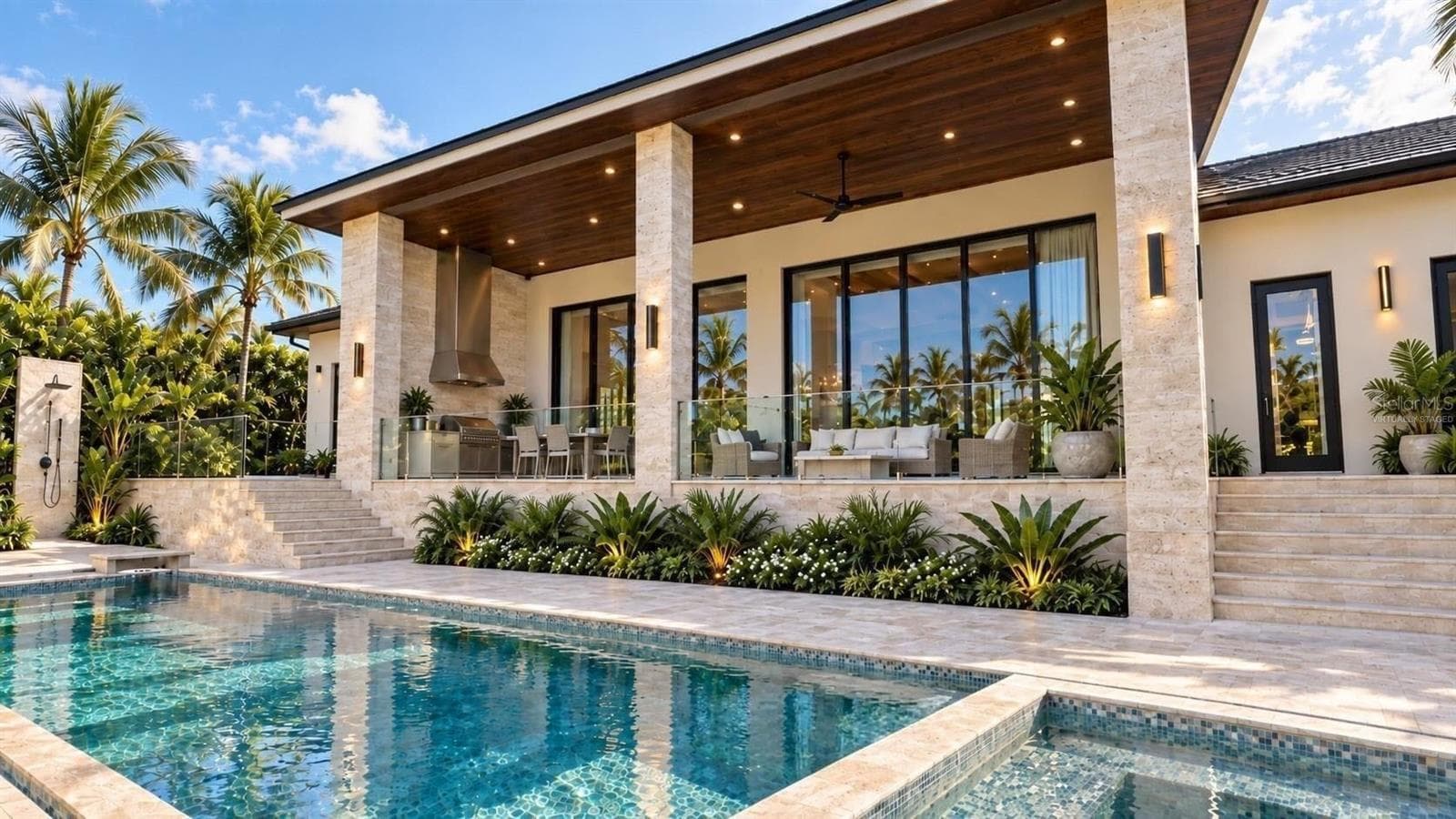 Patio with full outdoor kitchen, heated saltwater pool and hot tub spa. Virtually staged. - 3441 GULFMEAD DR, SARASOTA