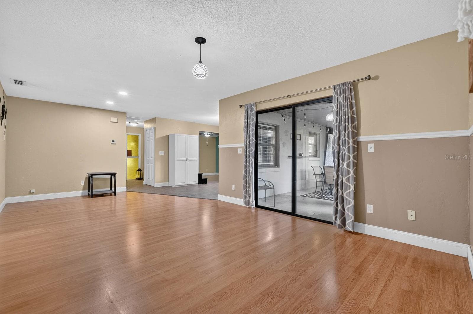 Living Area Opening to Lanai - 319 QUAKER RIDGE DR, DAYTONA BEACH