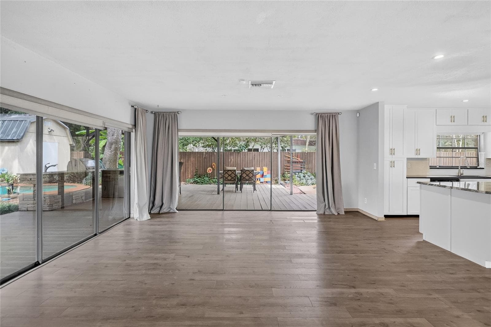 Expansive sliding glass doors fill the living and dining areas with natural light. - 3011 LAKE ELLEN DR, TAMPA