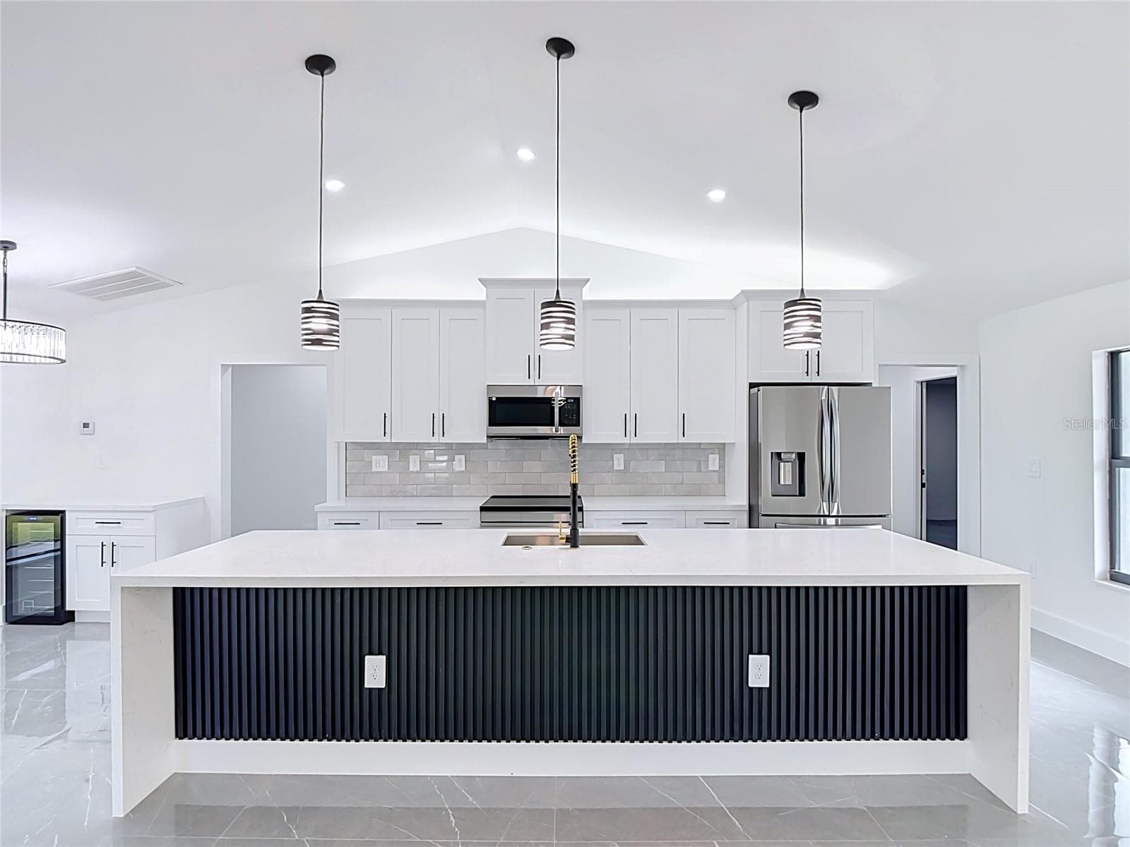 View of extraordinary gourmet kitchen with 10 foot Waterfall Island - 3613 NW 47TH LN, CAPE CORAL