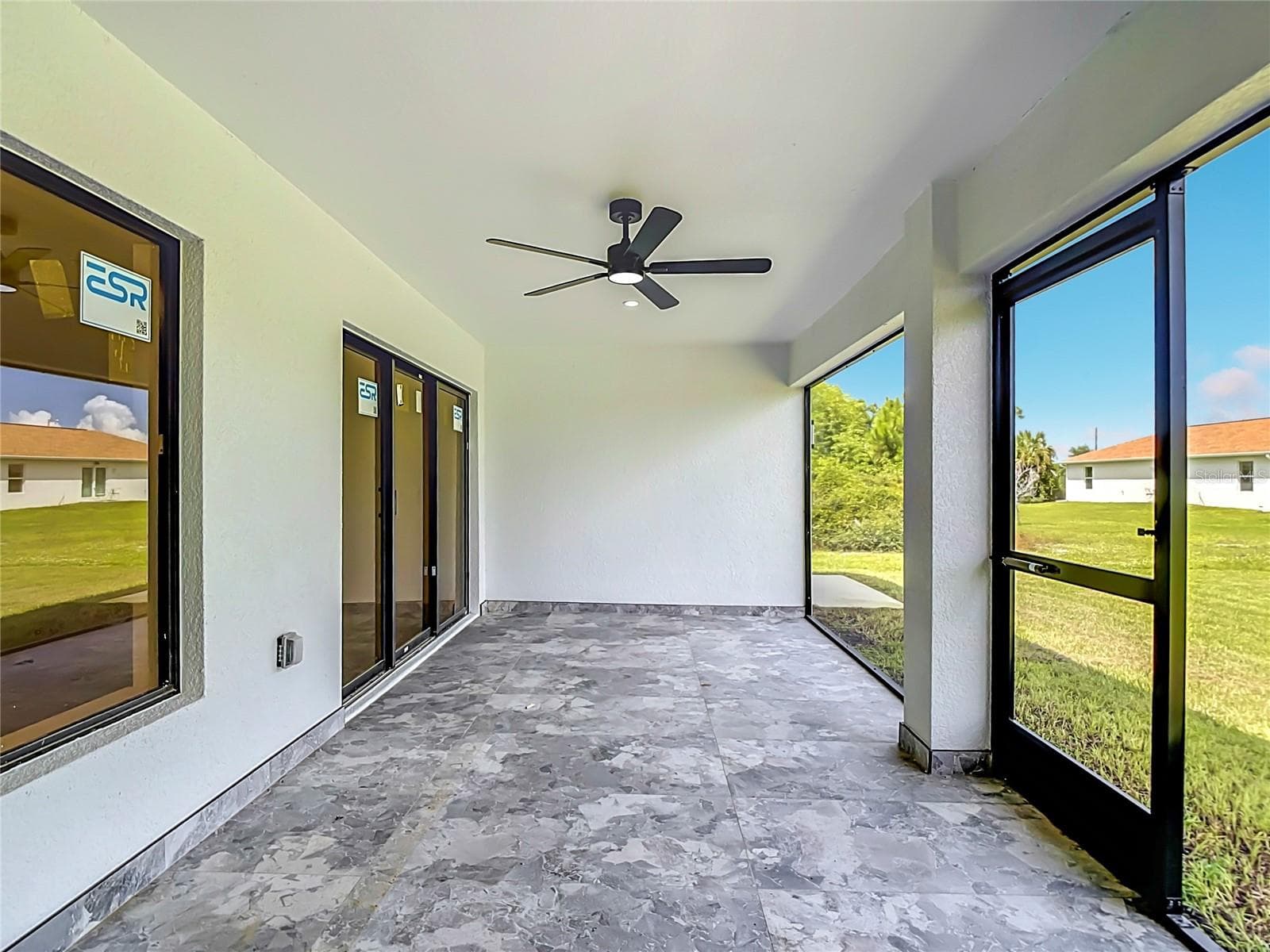 Screened lanai with ceramic tiling & overhead fan - 3613 NW 47TH LN, CAPE CORAL