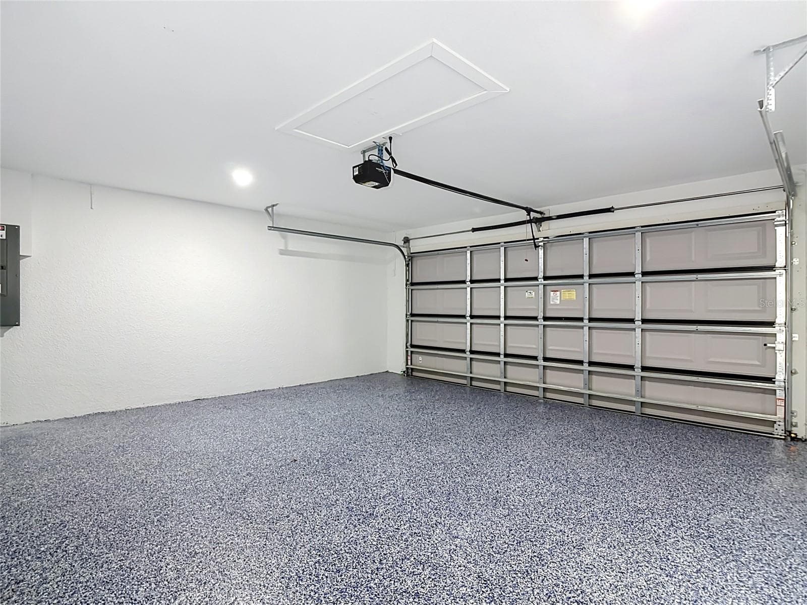 View of garage with finished flooring - 3613 NW 47TH LN, CAPE CORAL