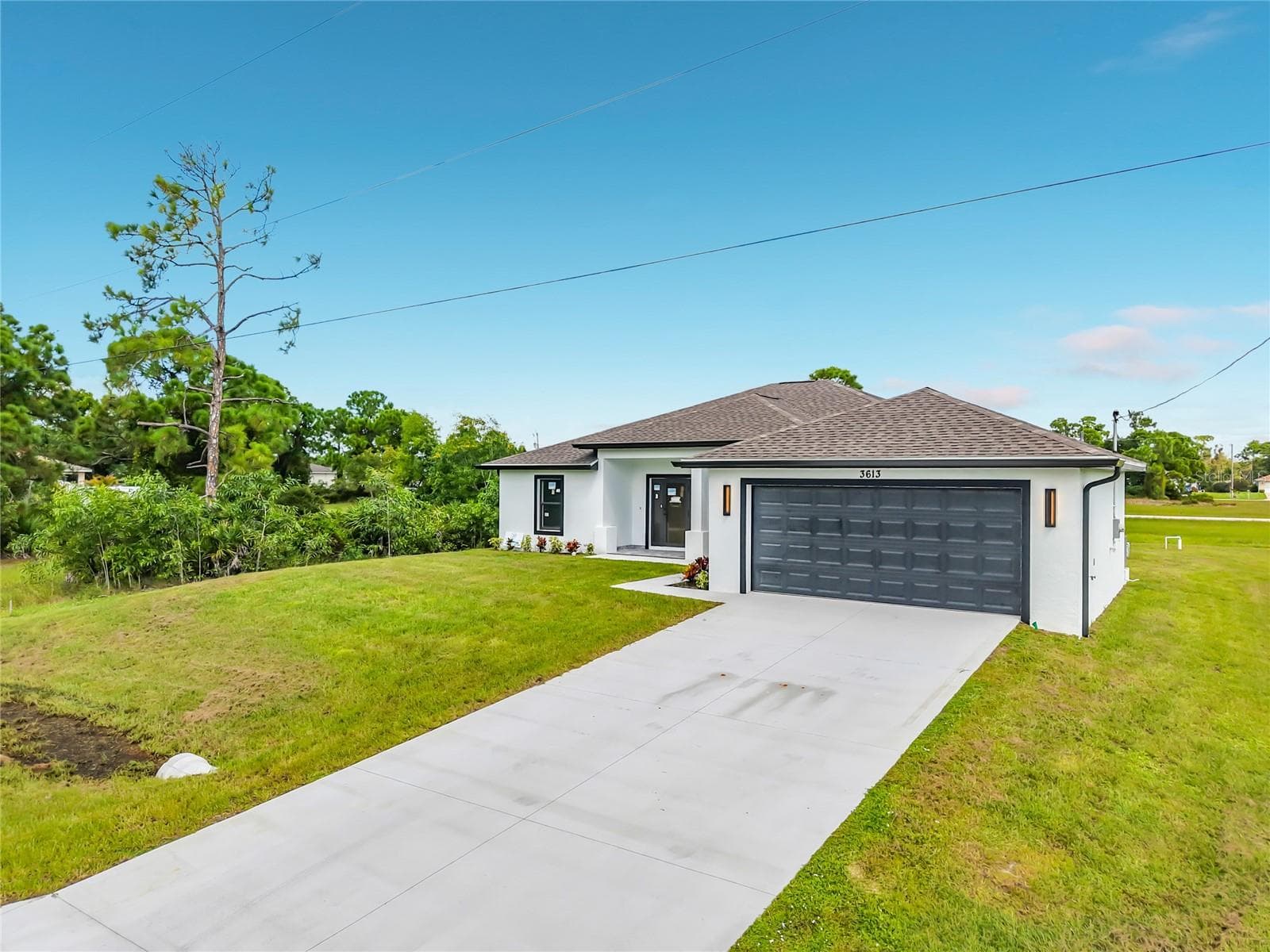 View of extra long driveway - park 4 or 8 cars easily! - 3613 NW 47TH LN, CAPE CORAL
