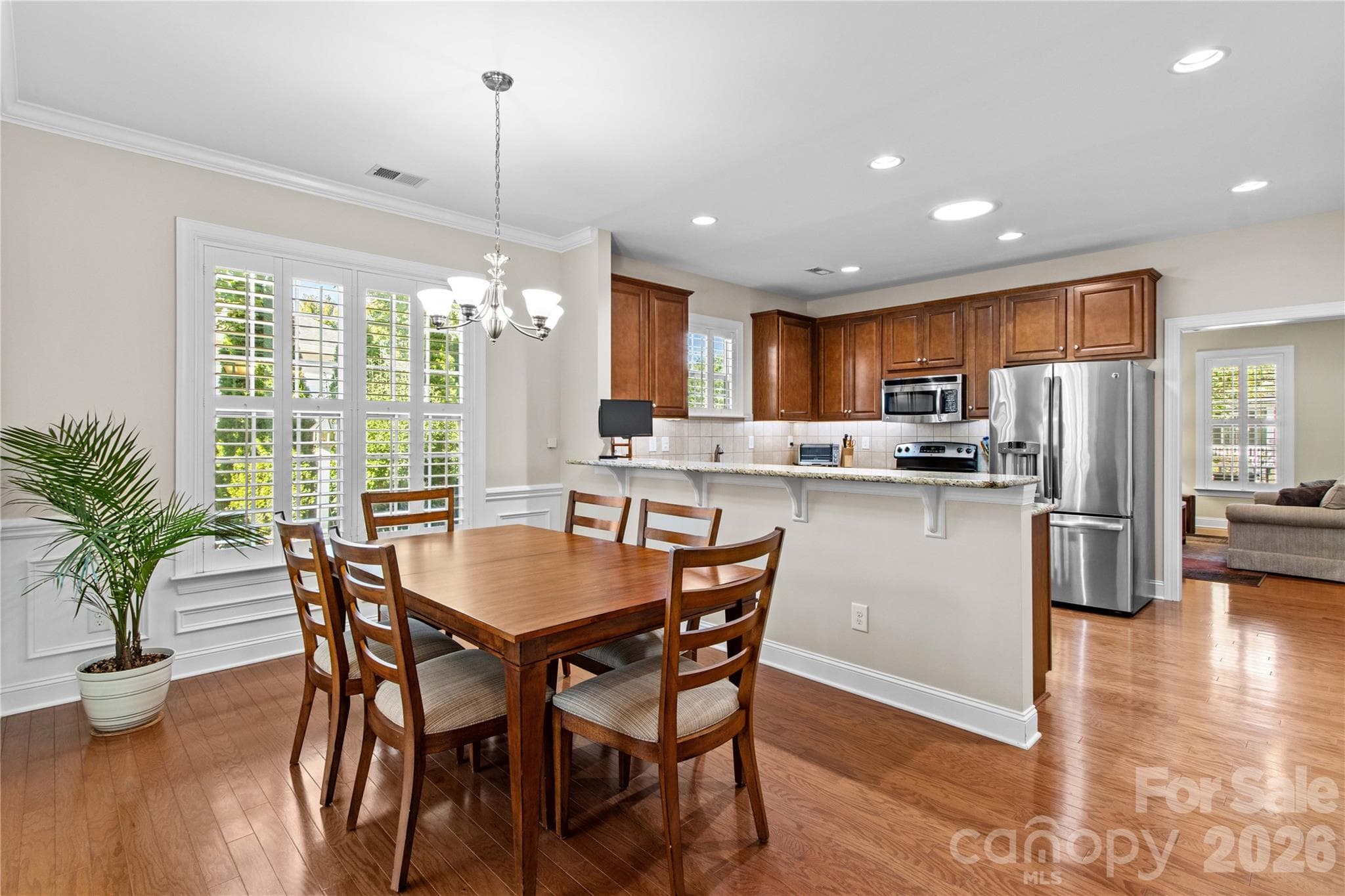 The dining area overlooks the side garden and can comfortably accommodate an expanded dining table. - 18114 Ebenezer Drive, Cornelius
