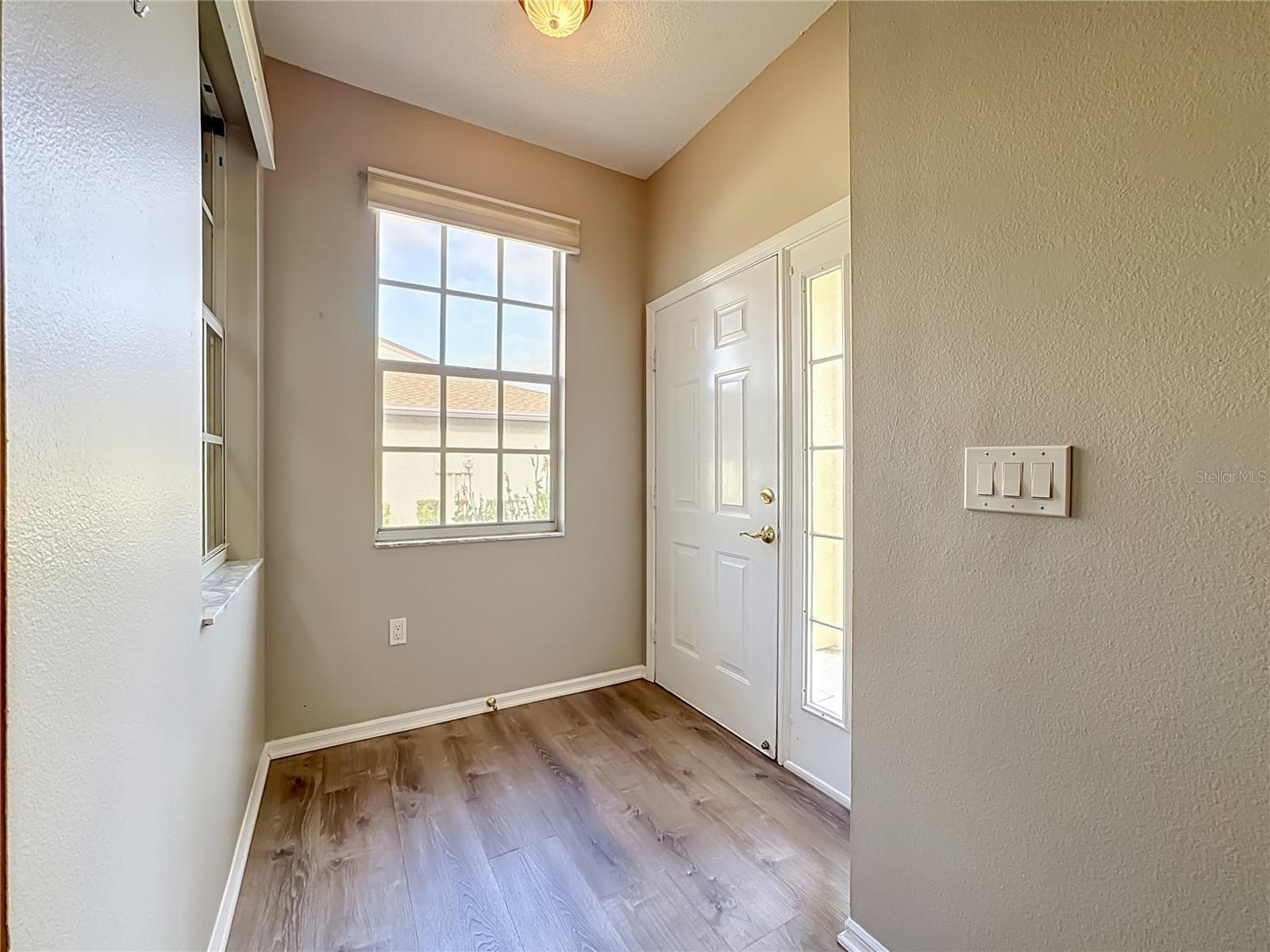 Entrance and foyer with luxury vinyl plank flooring. - 3308 60TH AVE W, BRADENTON