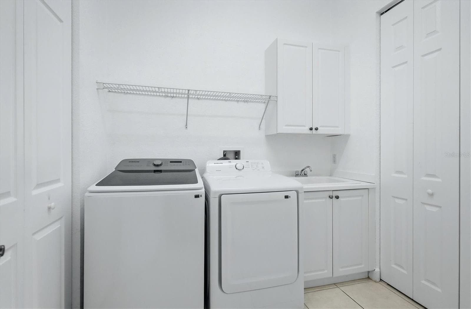 laundry room with cabinets and storage closet - 5458 46TH CT W, BRADENTON