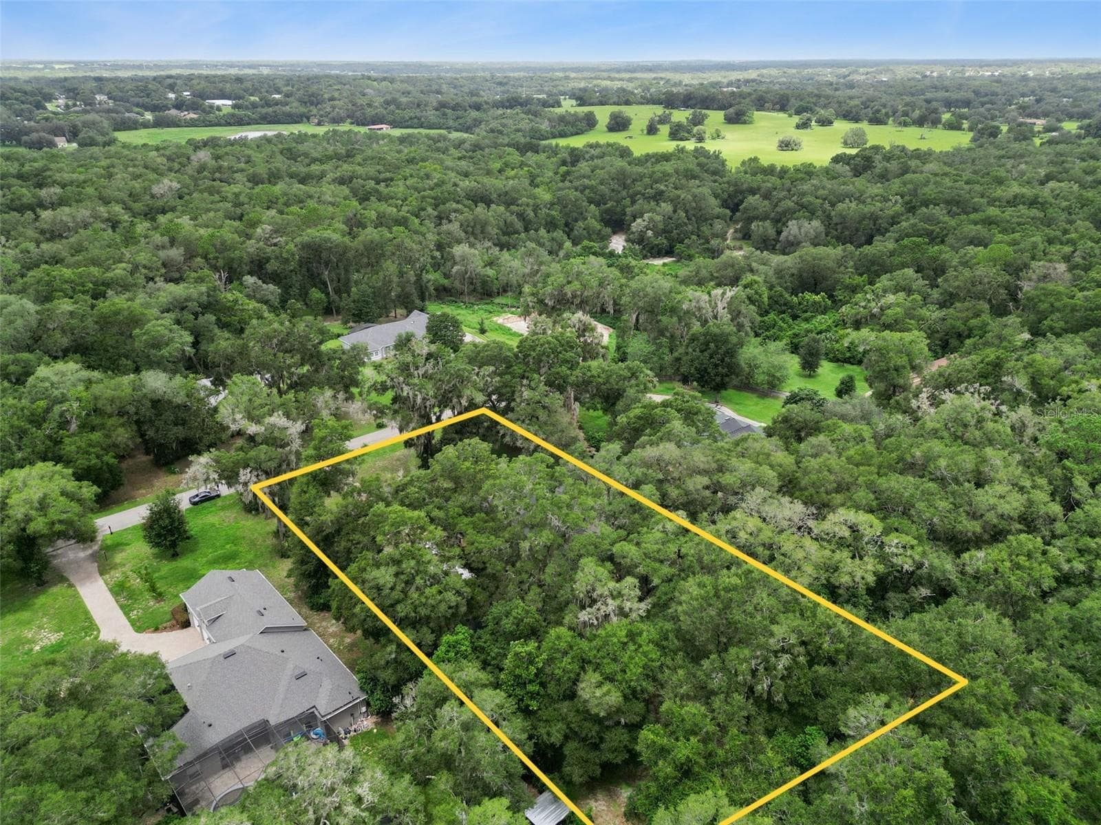 Elevated aerial showcases the wooded surroundings and spacious neighboring homesites. - 30440 JUBILEE WAY, SORRENTO