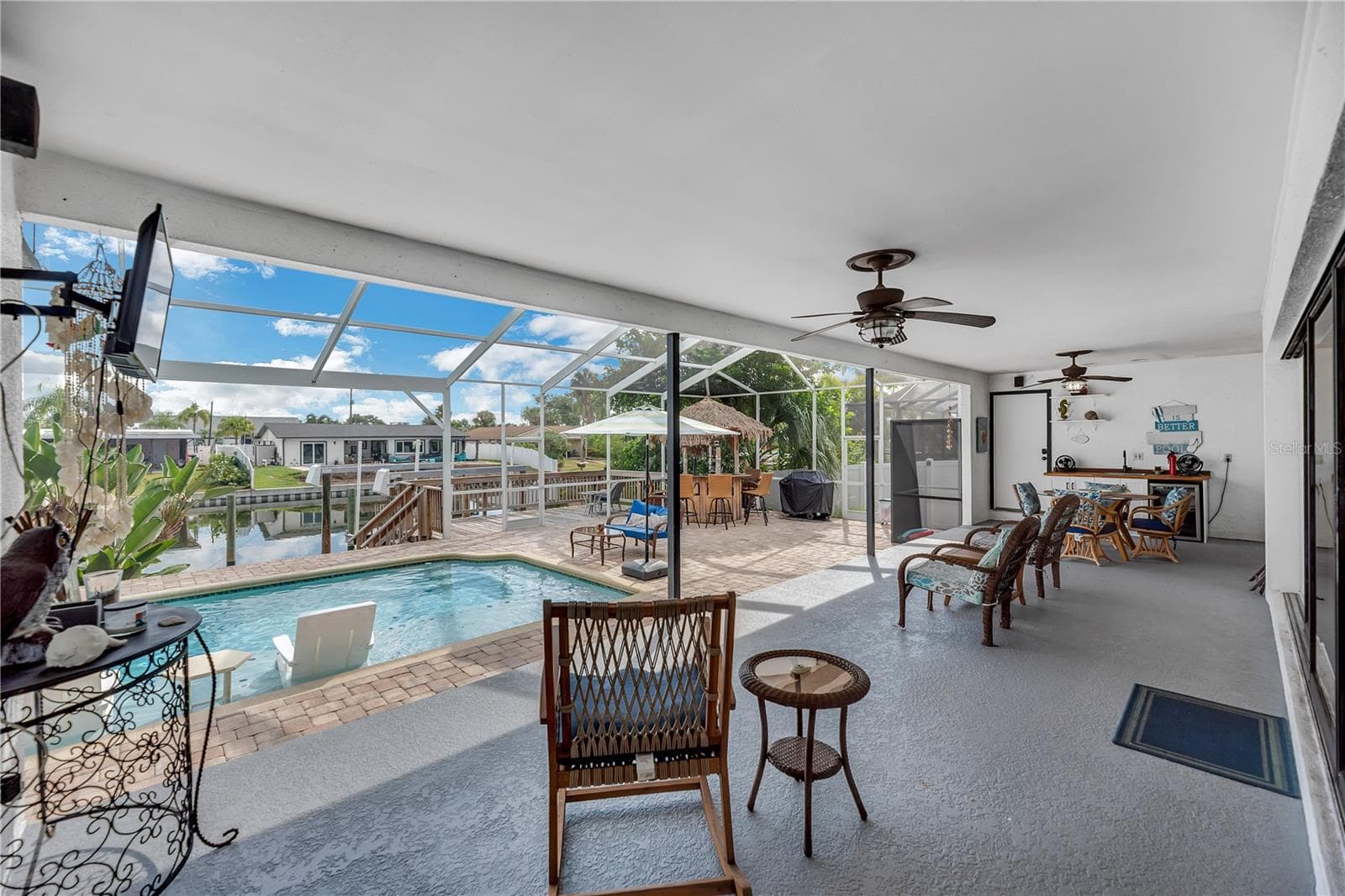 This backyard porch is raised up 2 steps from the pool deck. - 743 KINGSTON CT, APOLLO BEACH