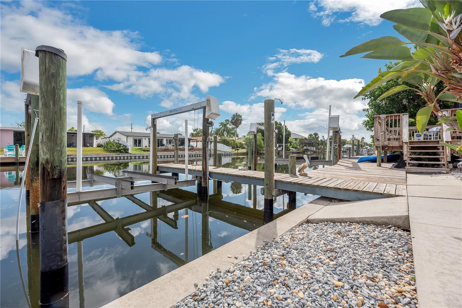 Low-maintenance stone landscaping enhances the outdoor space, while a second outdoor shower is conveniently located on the first dock piling. - 743 KINGSTON CT, APOLLO BEACH