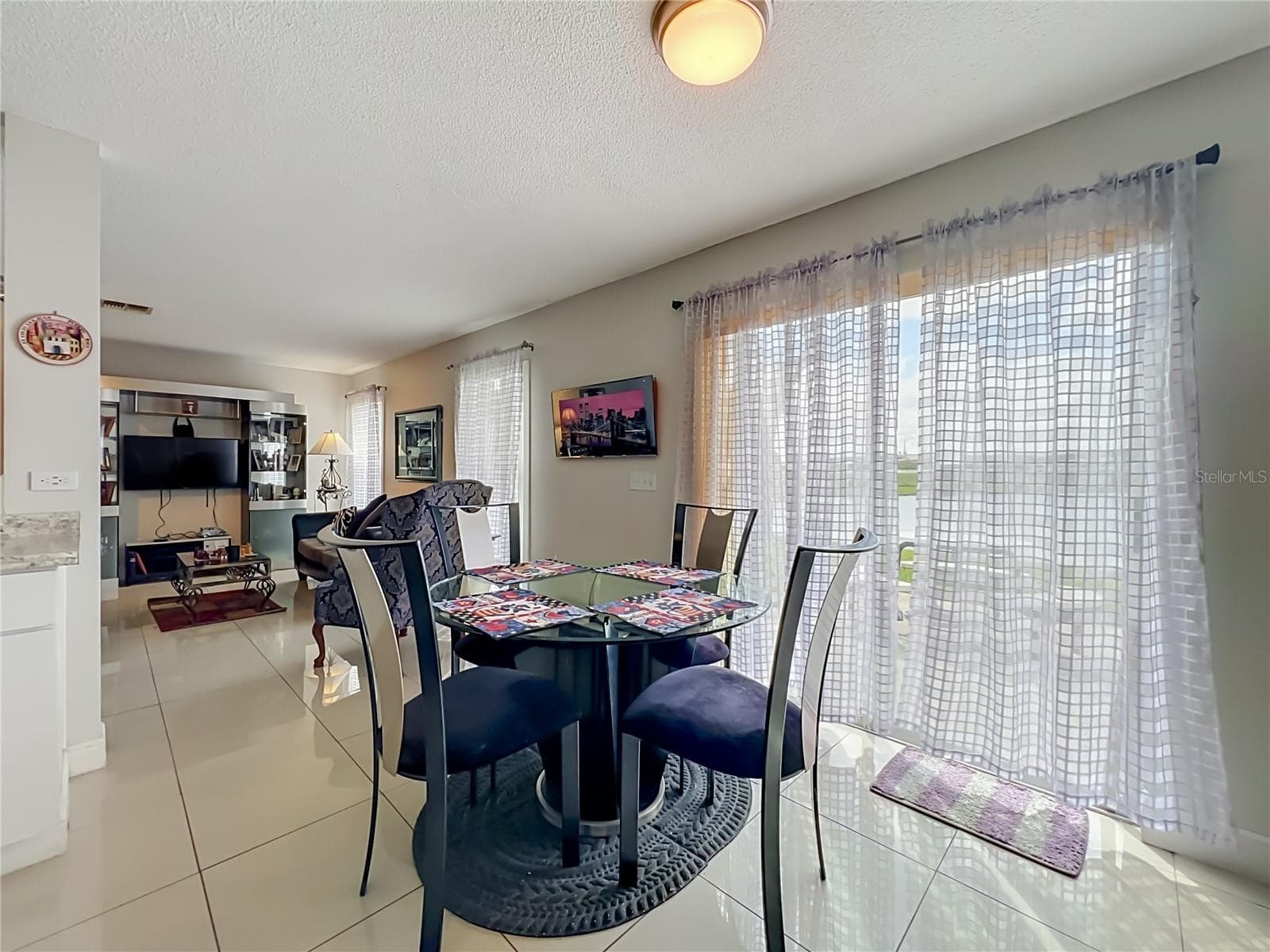 Dinette area with sliding doors to the back yard and pond front - 12900 LOS ALAMITOS CT, ORLANDO