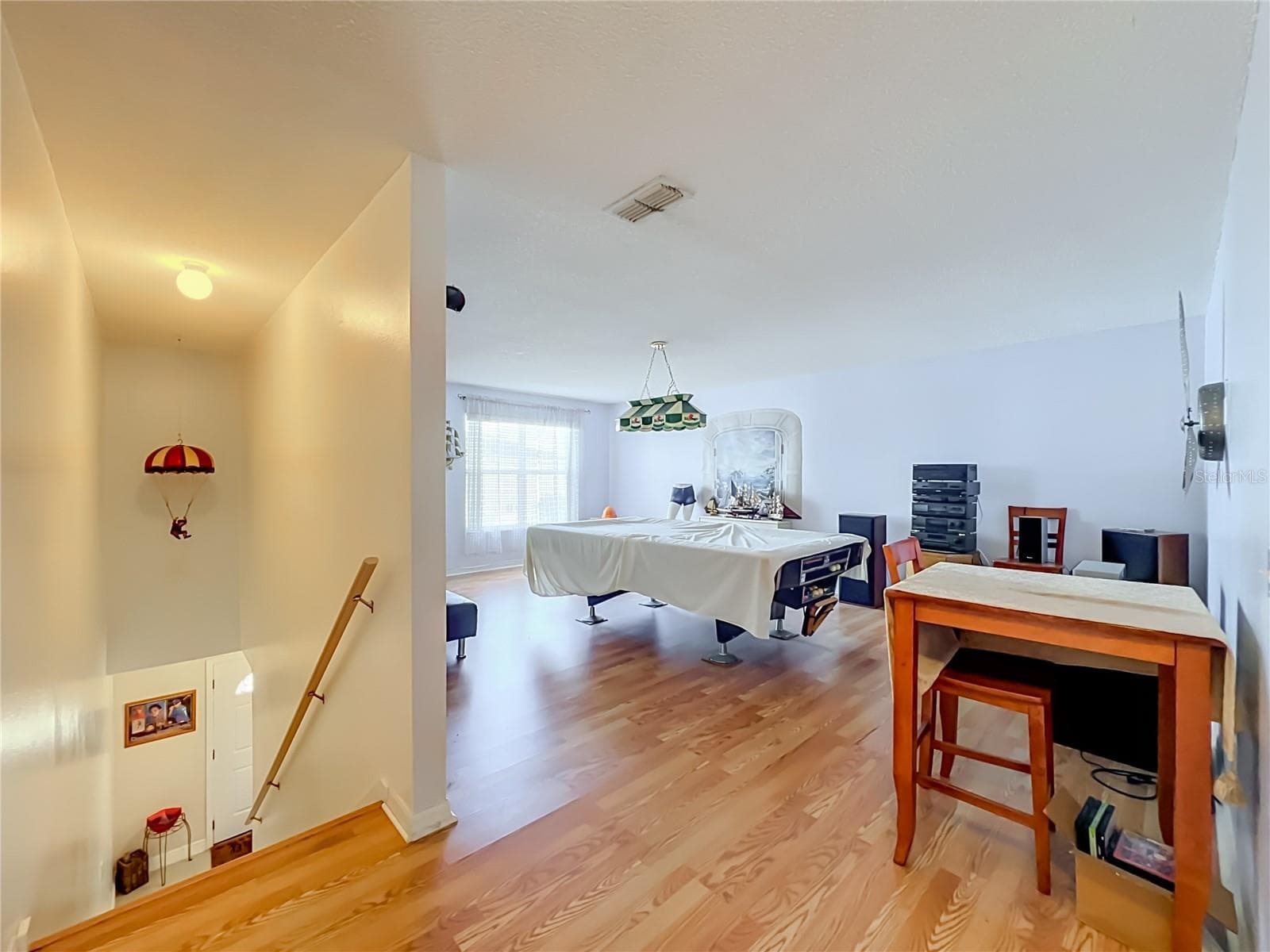 Wood laminate floors up the stairs and in the whole 2nd floor. This is a view of the large bonus room which could be a 5th bedroom if desired because there is a large closet currently used as an office. - 12900 LOS ALAMITOS CT, ORLANDO