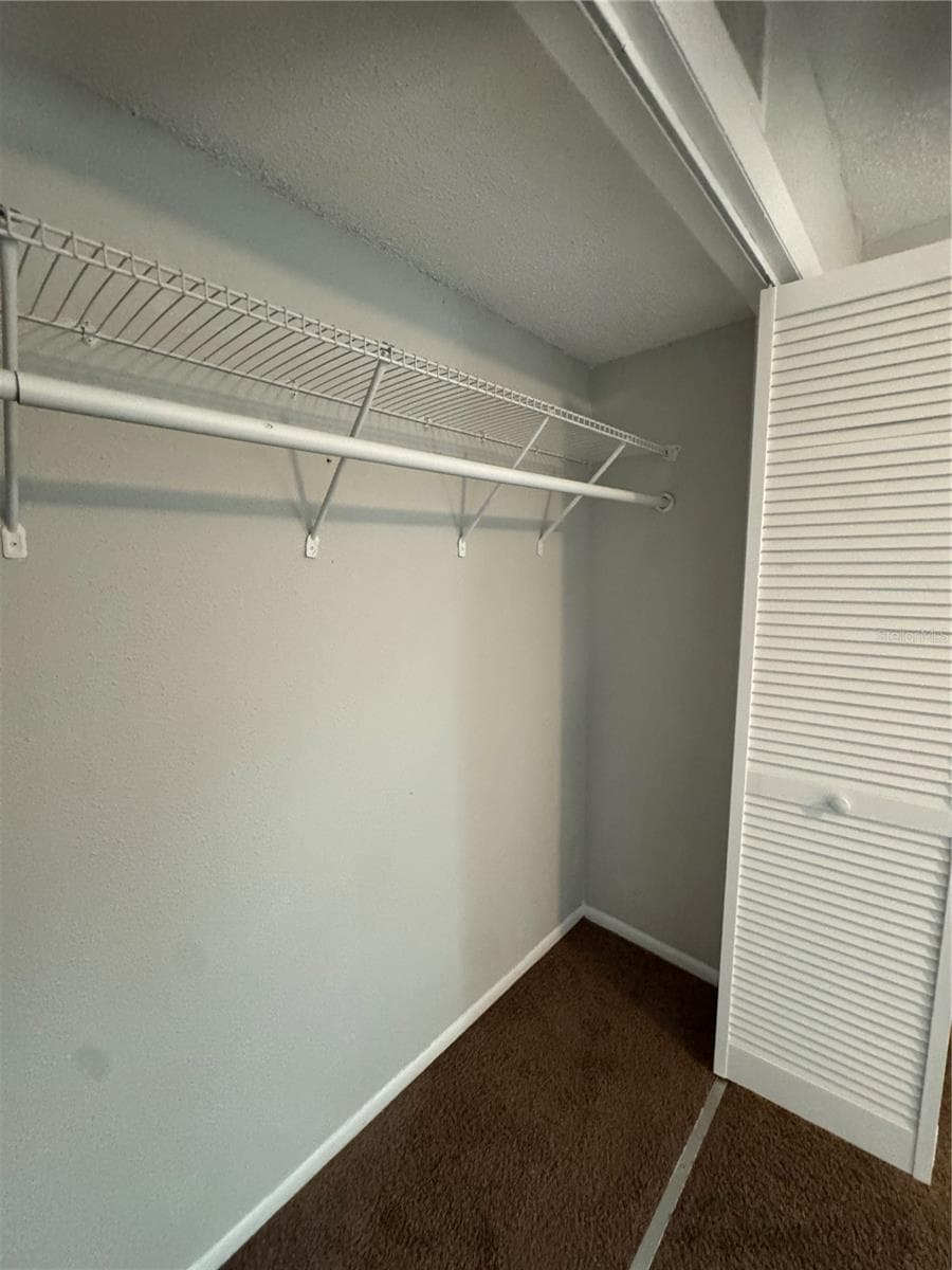 GUEST BEDROOM STARDARD CLOSET WITH BI-FOLD DOORS - 2884 SOMERSET PARK DR #2907, TAMPA