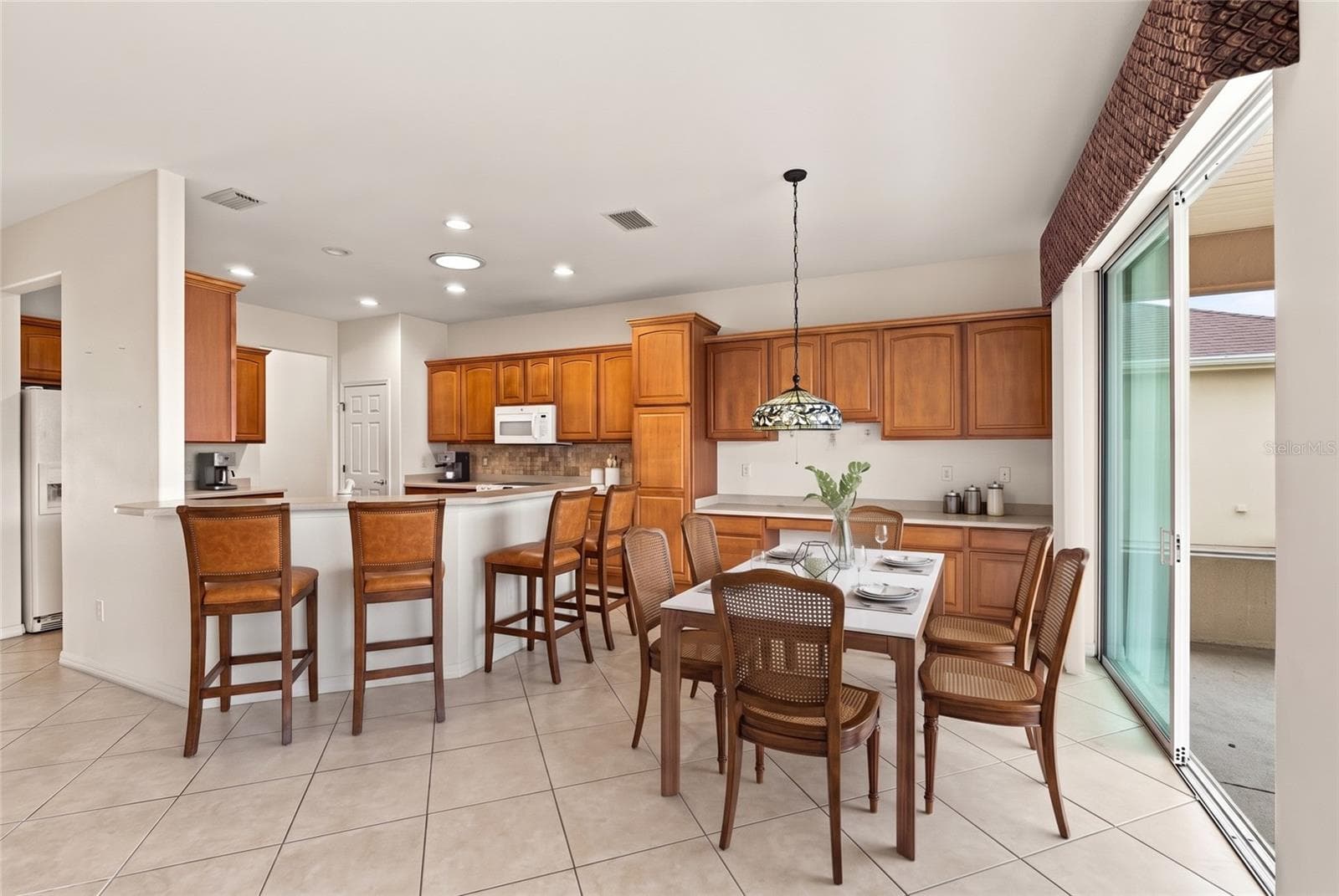 Kitchen, dining area, bar staged - 11811 SE 91ST CIR, SUMMERFIELD