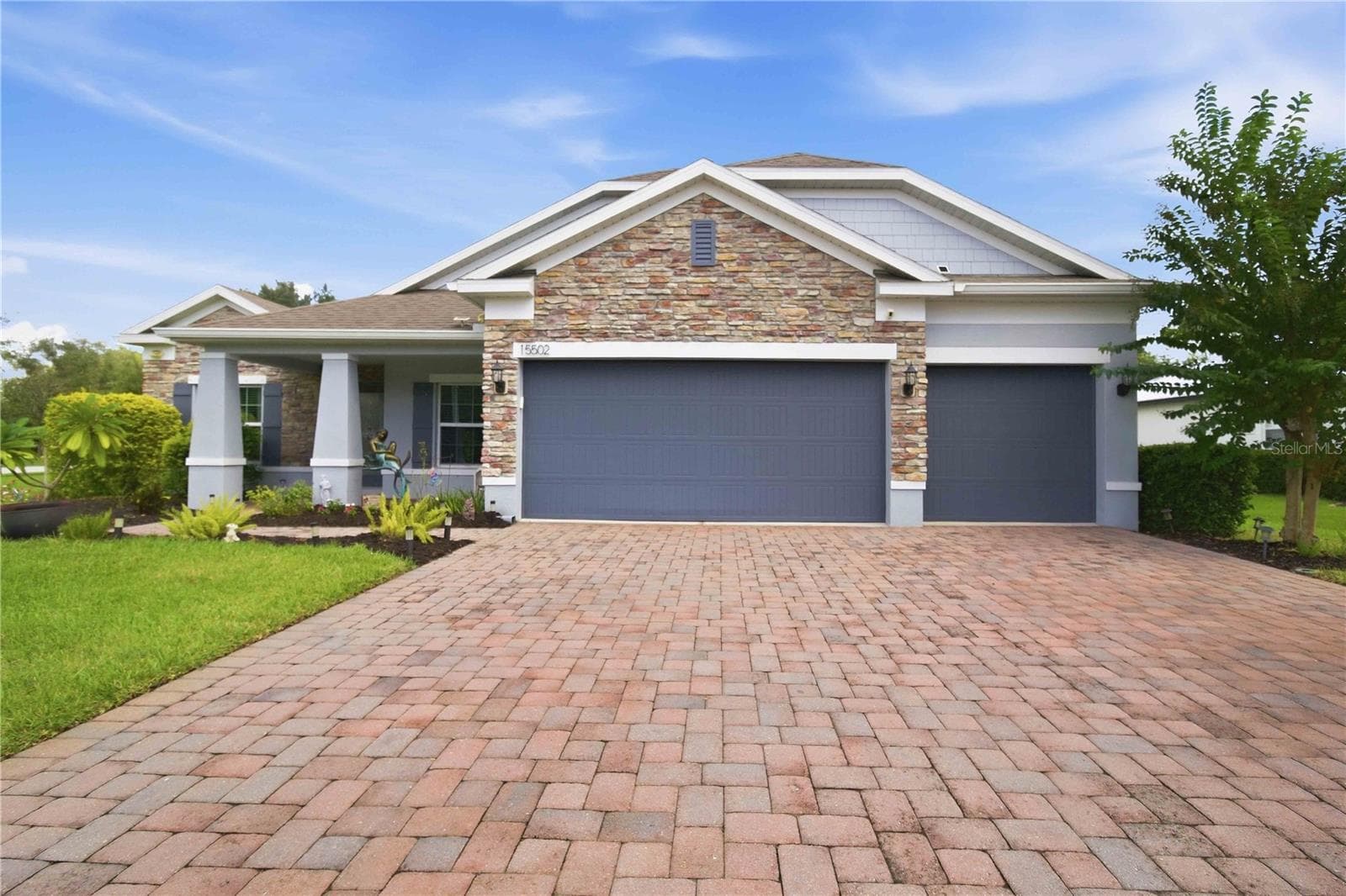 Daytime front exterior with inviting curb appeal. - 15502 31ST ST E, PARRISH
