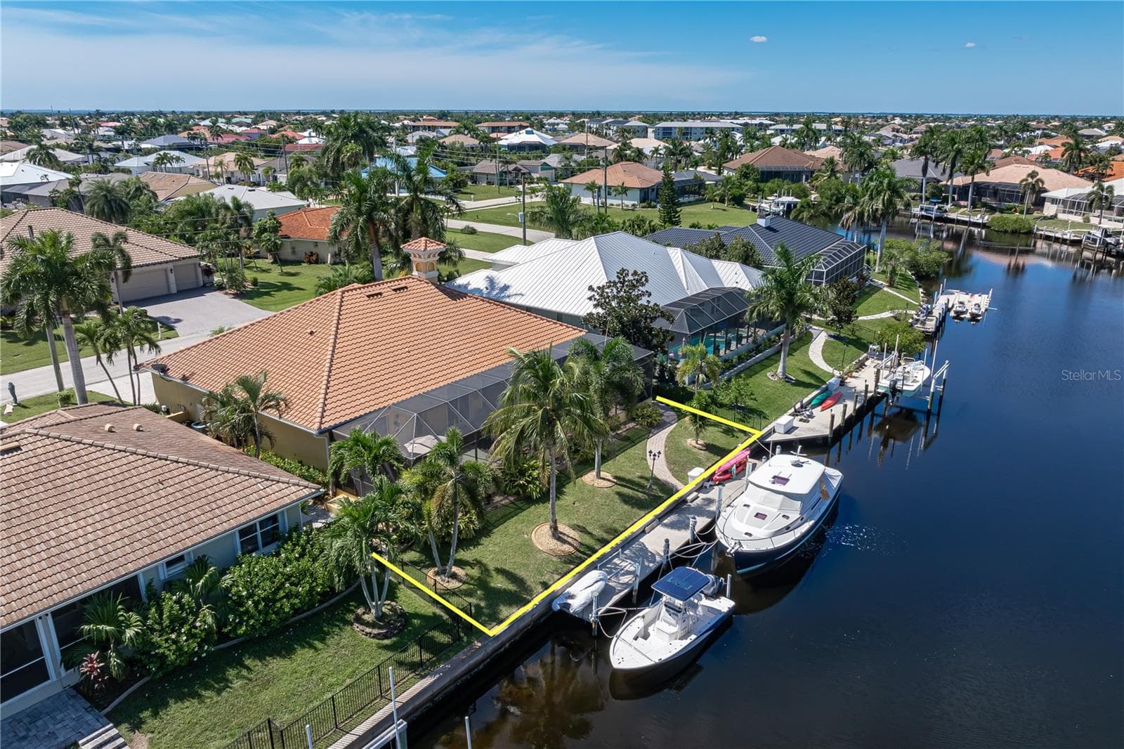 Tropical landscaping surrounds the home - 1448 KIWI CT, PUNTA GORDA