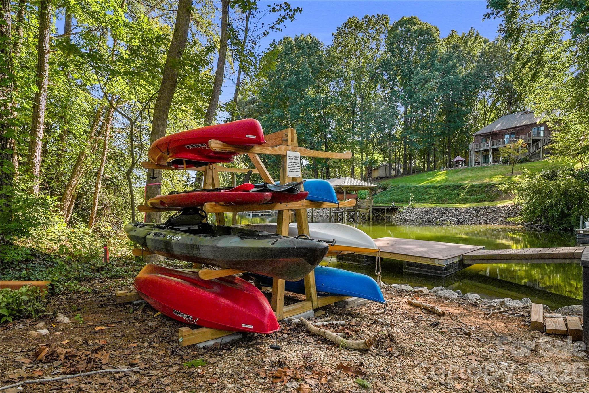 A rack keeps kayaks and paddle boards at the ready for time on the water. - 143 Hideaway Lane, Mooresville