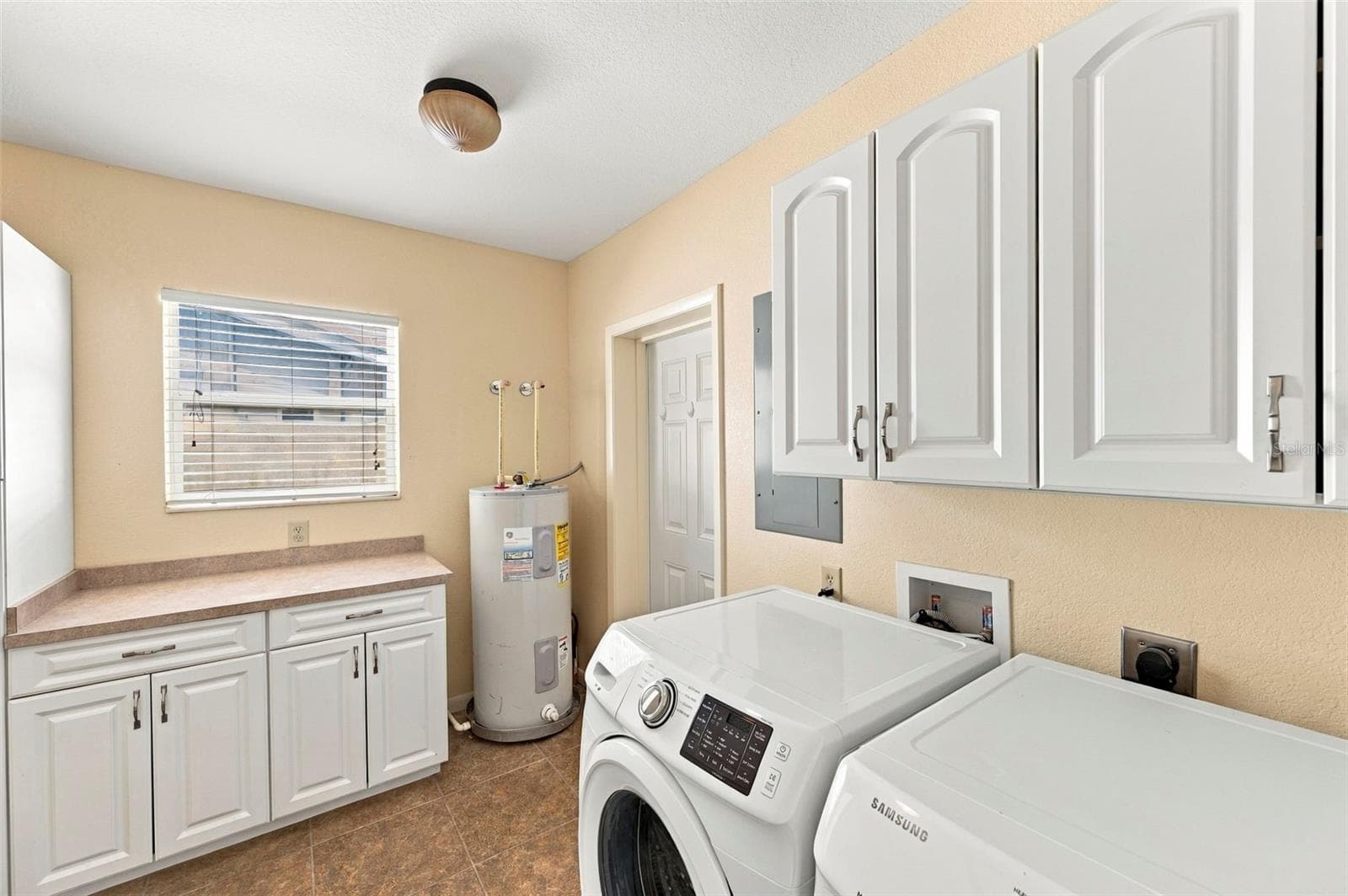 Laundry Room with ample storage space and access to the backyard - 620 PALM PL, SAFETY HARBOR