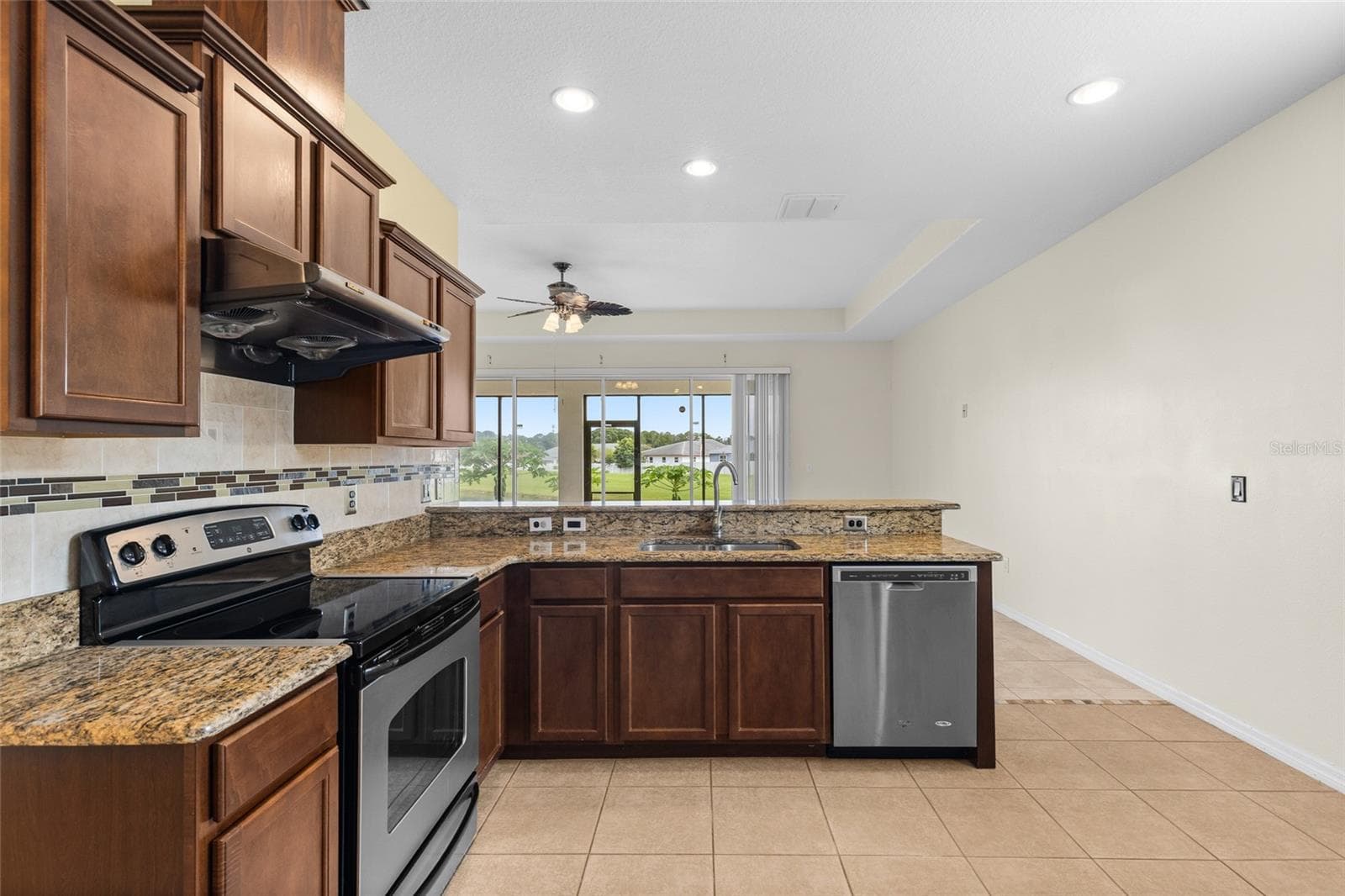 Kitchen Also Overlook Into Living Room And Backyard - 3652 MADBURY CIR, LAKELAND