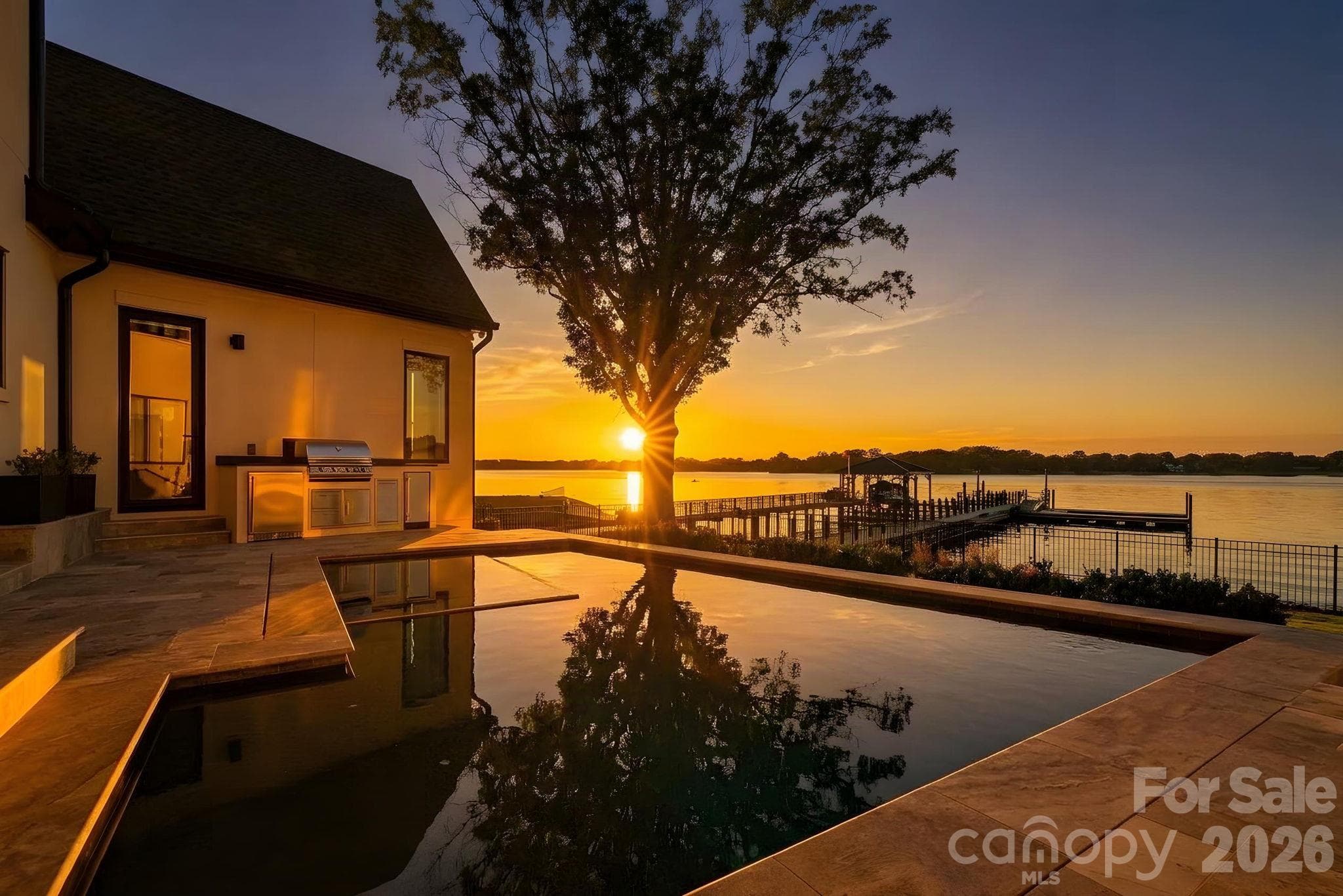 Golden-hour living at its finest, where the pool, spa and waterfront converge against a backdrop of sweeping Lake Norman sunsets. - 17811 Largo Place, Cornelius