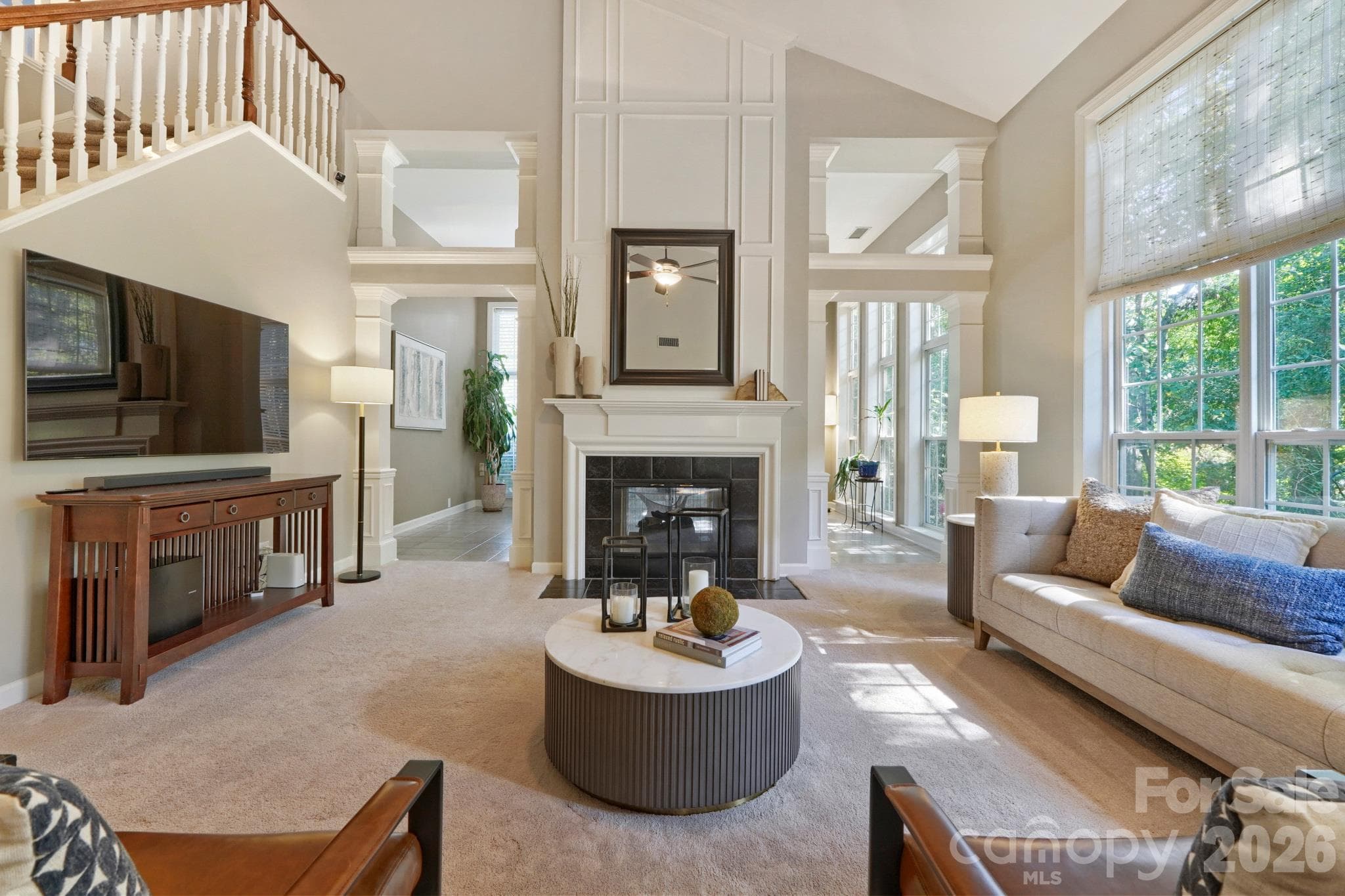 Two story light filled living room with two sided gas fireplace - 10808 Pomerane Place, Charlotte
