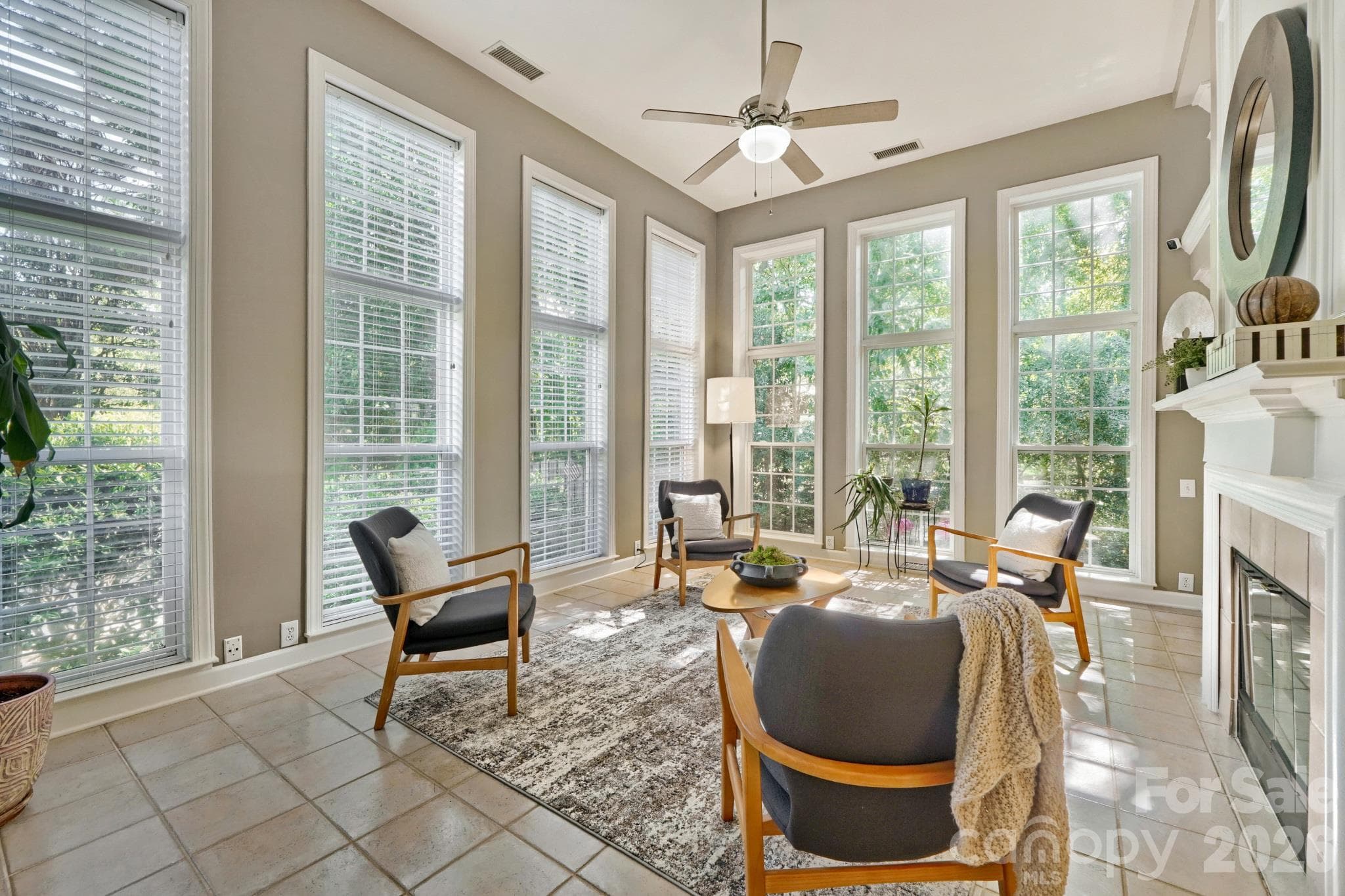 Two story light filled sunroom with two sided gas fireplace - 10808 Pomerane Place, Charlotte