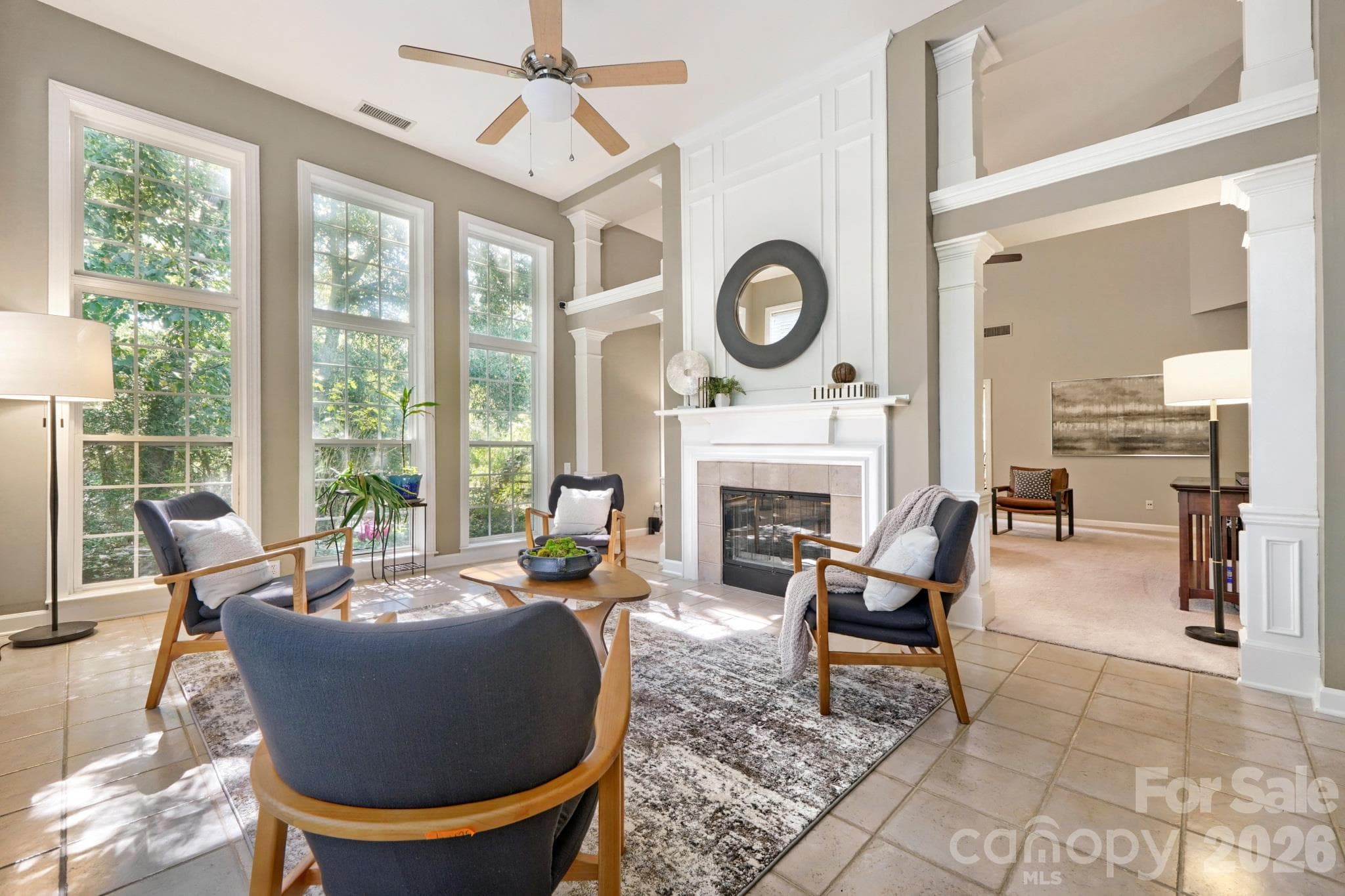 Two story light filled sunroom with two sided gas fireplace - 10808 Pomerane Place, Charlotte