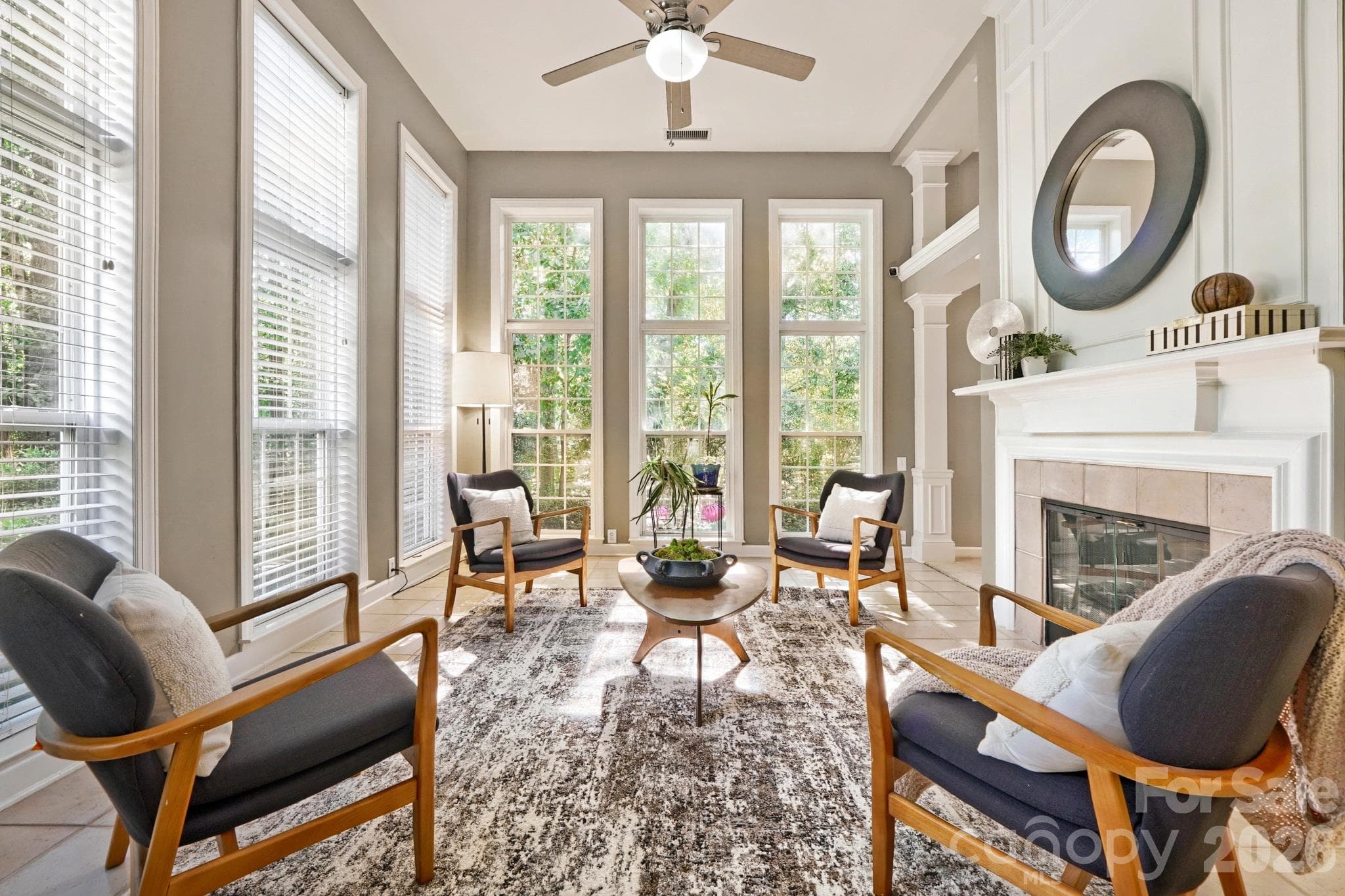 Two story light filled sunroom with two sided gas fireplace - 10808 Pomerane Place, Charlotte
