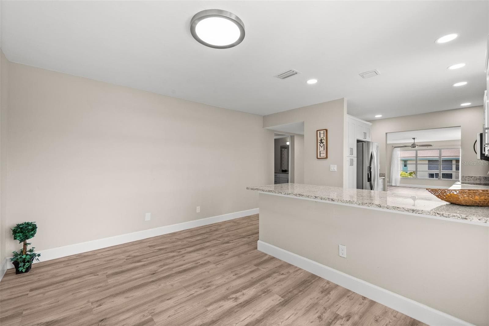 Looking from the front door to the breakfast nook and kitchen - 1345 SE 40TH TER #2E, CAPE CORAL