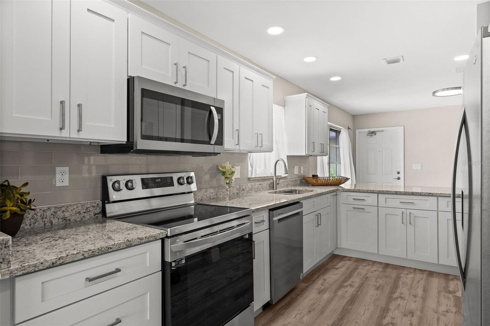 Looking through the kitchen toward the entry - 1345 SE 40TH TER #2E, CAPE CORAL