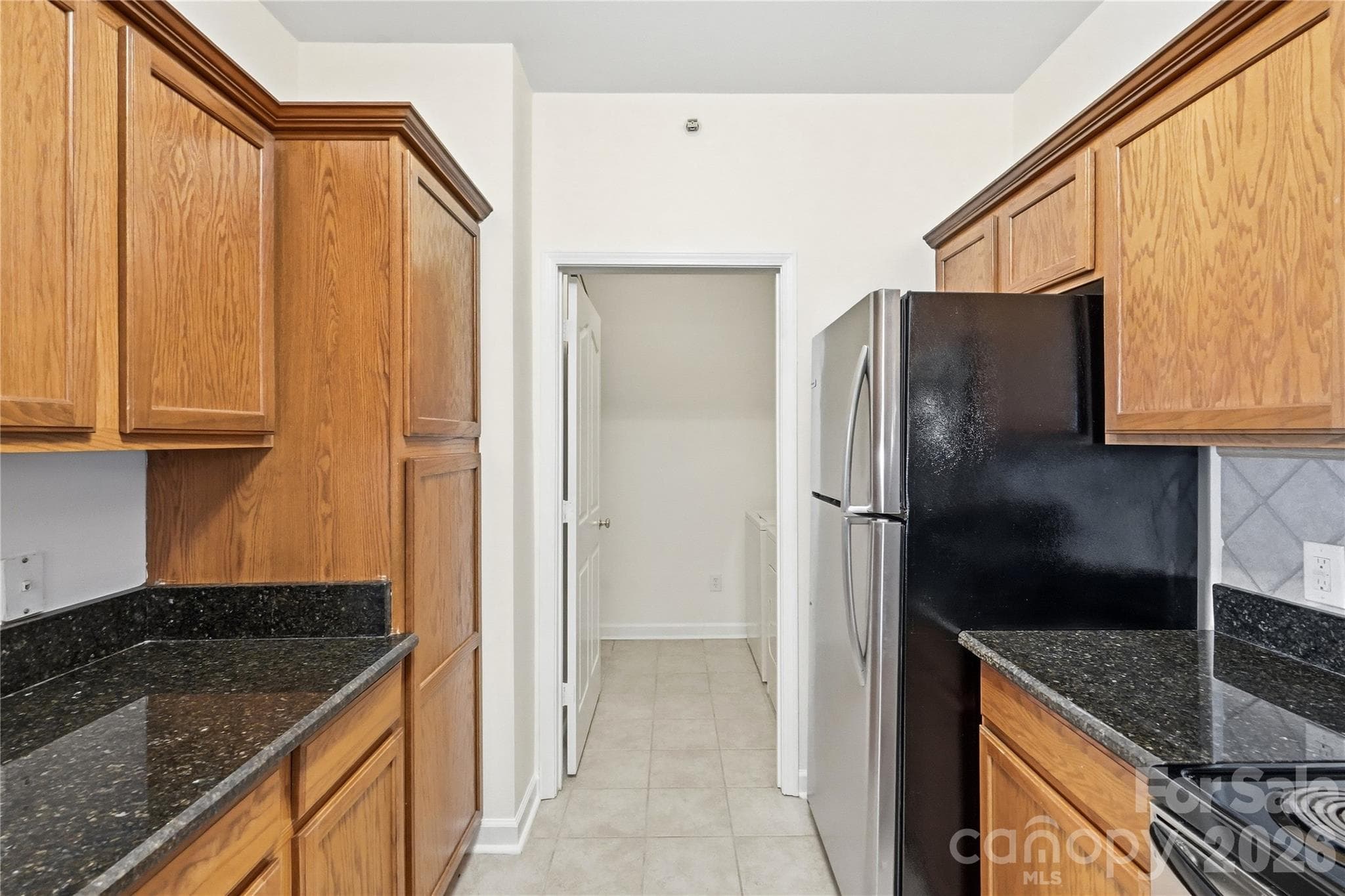 Kitchen into the laundry room - 16406 Redstone Mountain Lane, Charlotte