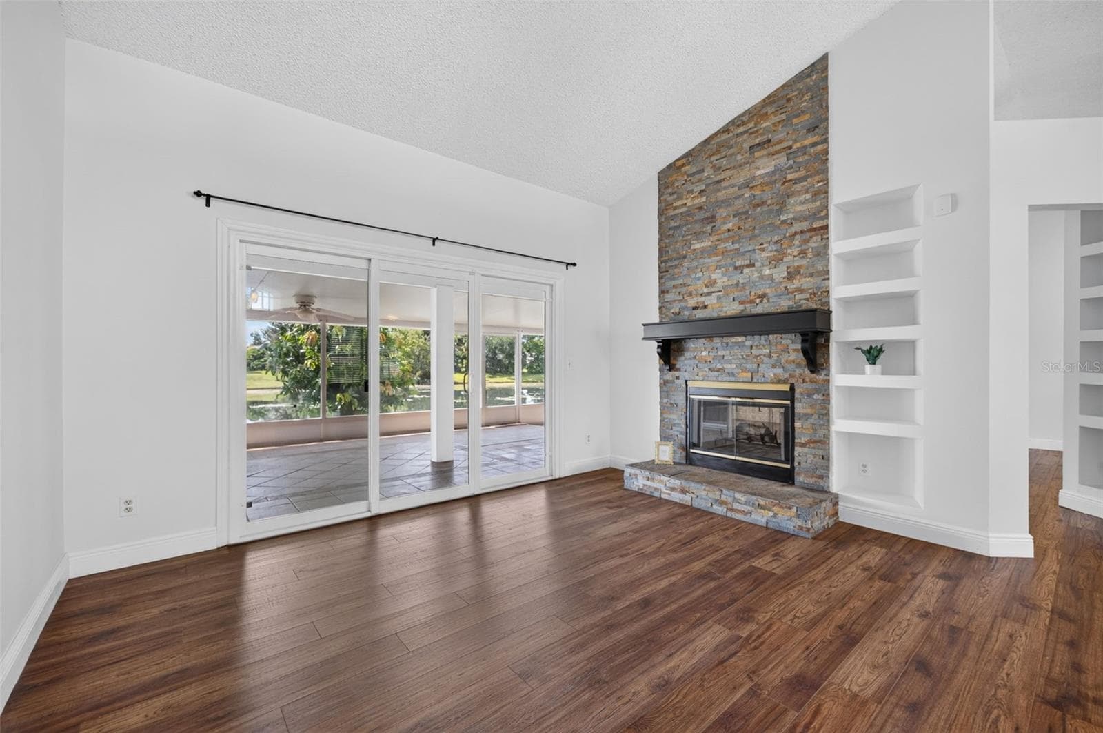 The custom stone work on the wood burning fireplace adds style and warmth to the room. - 2925 EAGLE LAKE DR, ORLANDO