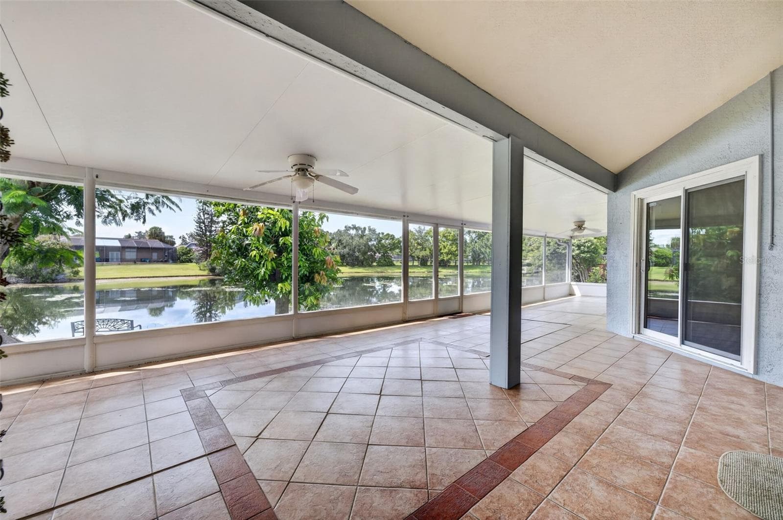 The large back patio offers more than 700 square feet of lakefront entertaining and relaxation space! - 2925 EAGLE LAKE DR, ORLANDO