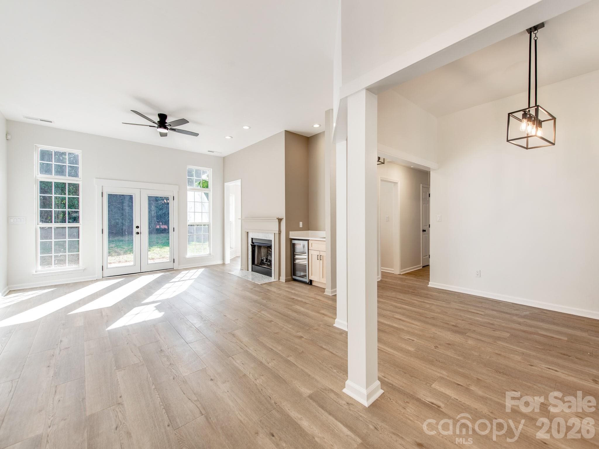 Open family room and dining room with architectural columns for separation - 810 Greenhill Drive, Charlotte
