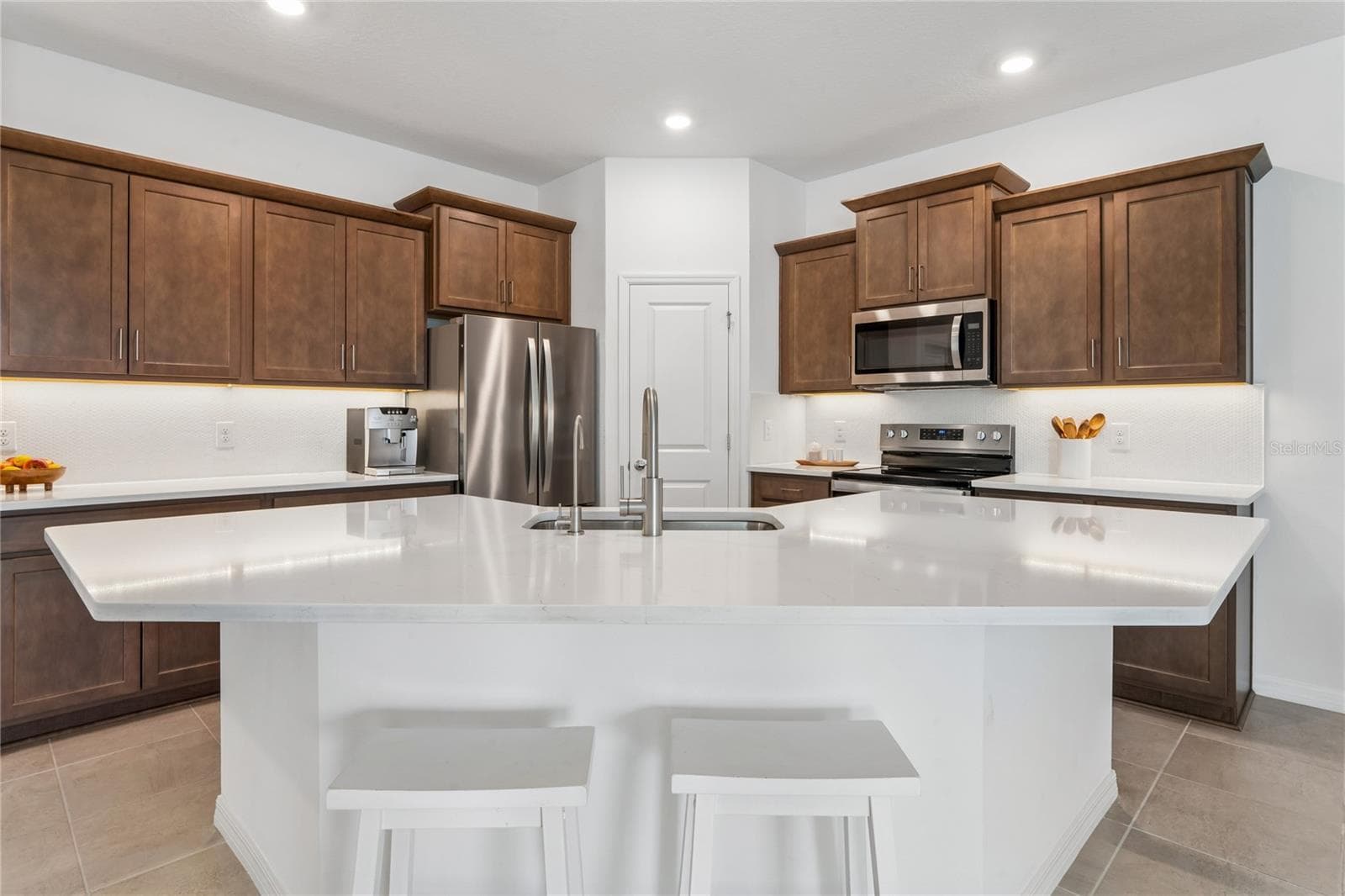 Almost 12ft kitchen prep Island with sink, diswasher, and seating area - 8580 BOLD CYPRESS LN, WESLEY CHAPEL