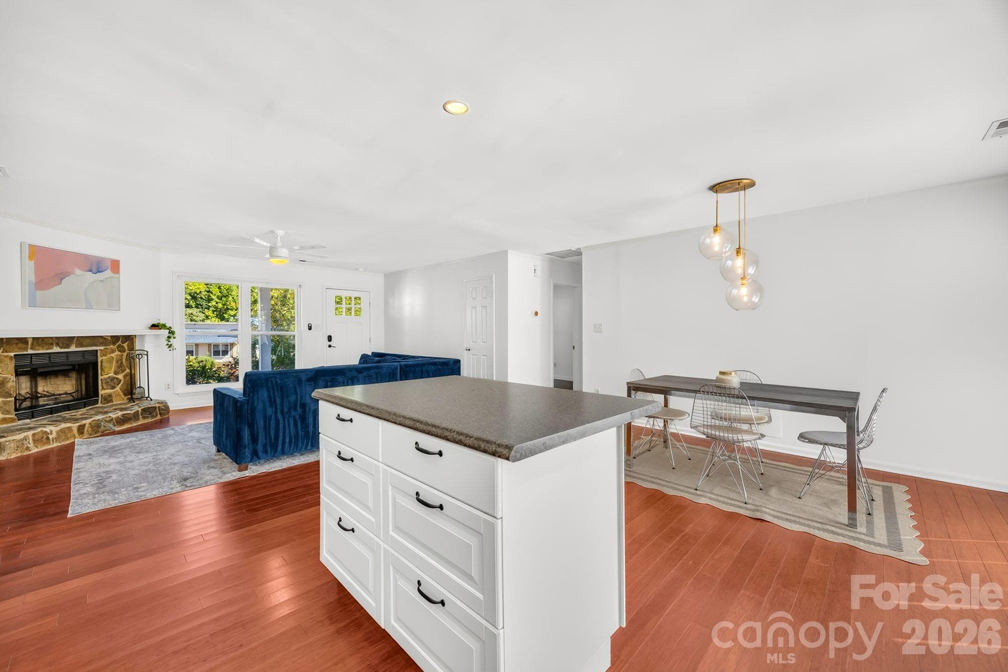 Open floor plan connecting the kitchen, dining area and living room on one level - 4900 Cricklewood Lane, Charlotte