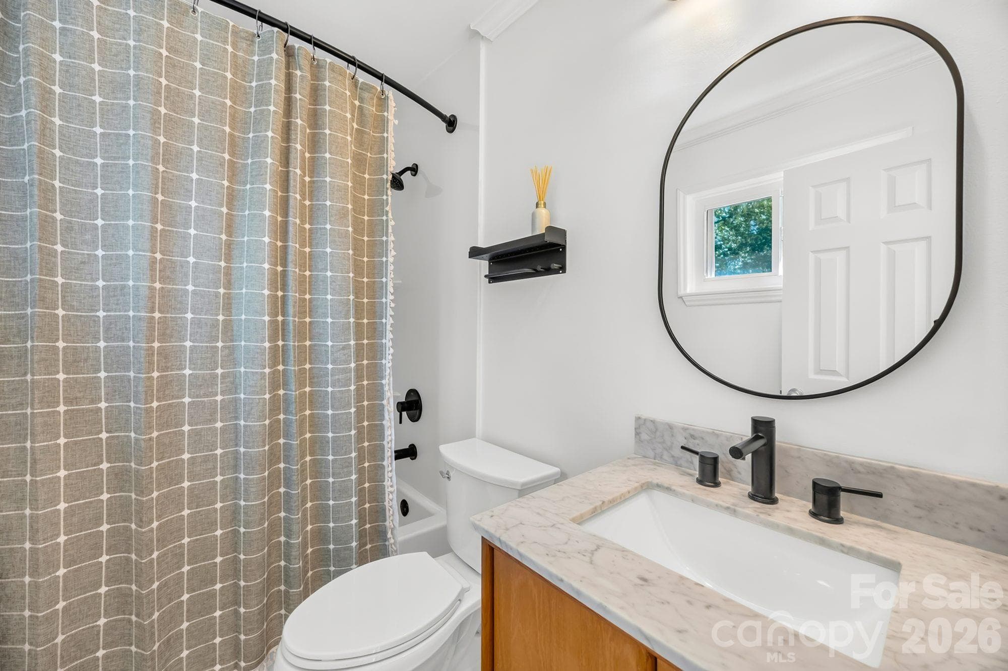 Updated full bathroom with modern vanity and matte black fixtures, remodeled in 2022 - 4900 Cricklewood Lane, Charlotte
