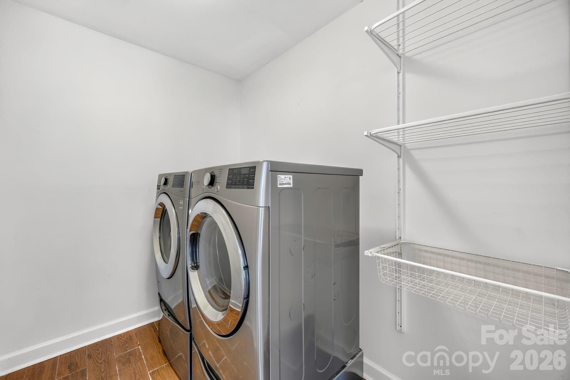 Laundry room with built-in shelving inside the home at 4900 Cricklewood Ln - 4900 Cricklewood Lane, Charlotte