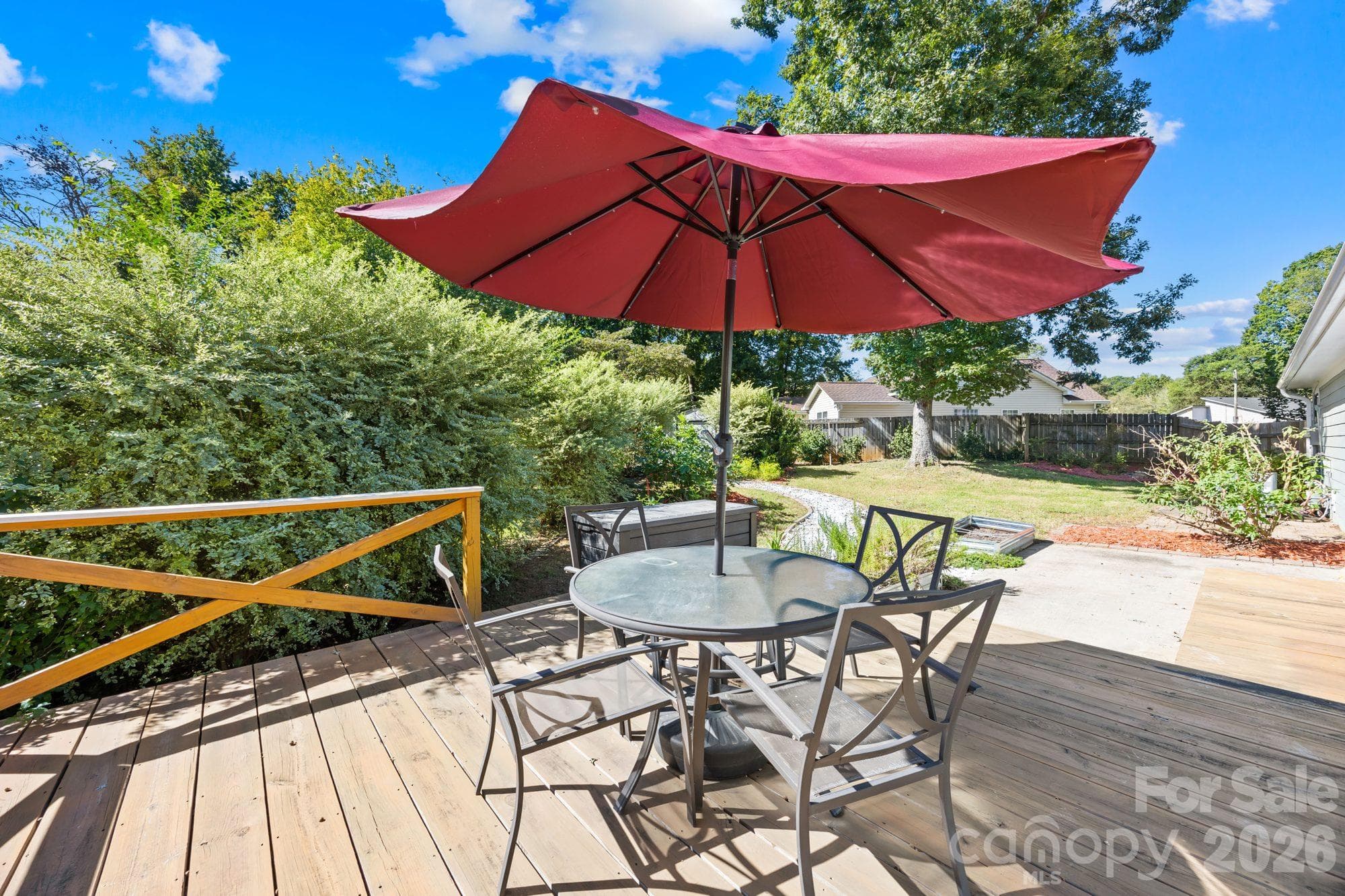 Back deck with room for outdoor dining, overlooking a 0.34-acre lot in East Charlotte - 4900 Cricklewood Lane, Charlotte