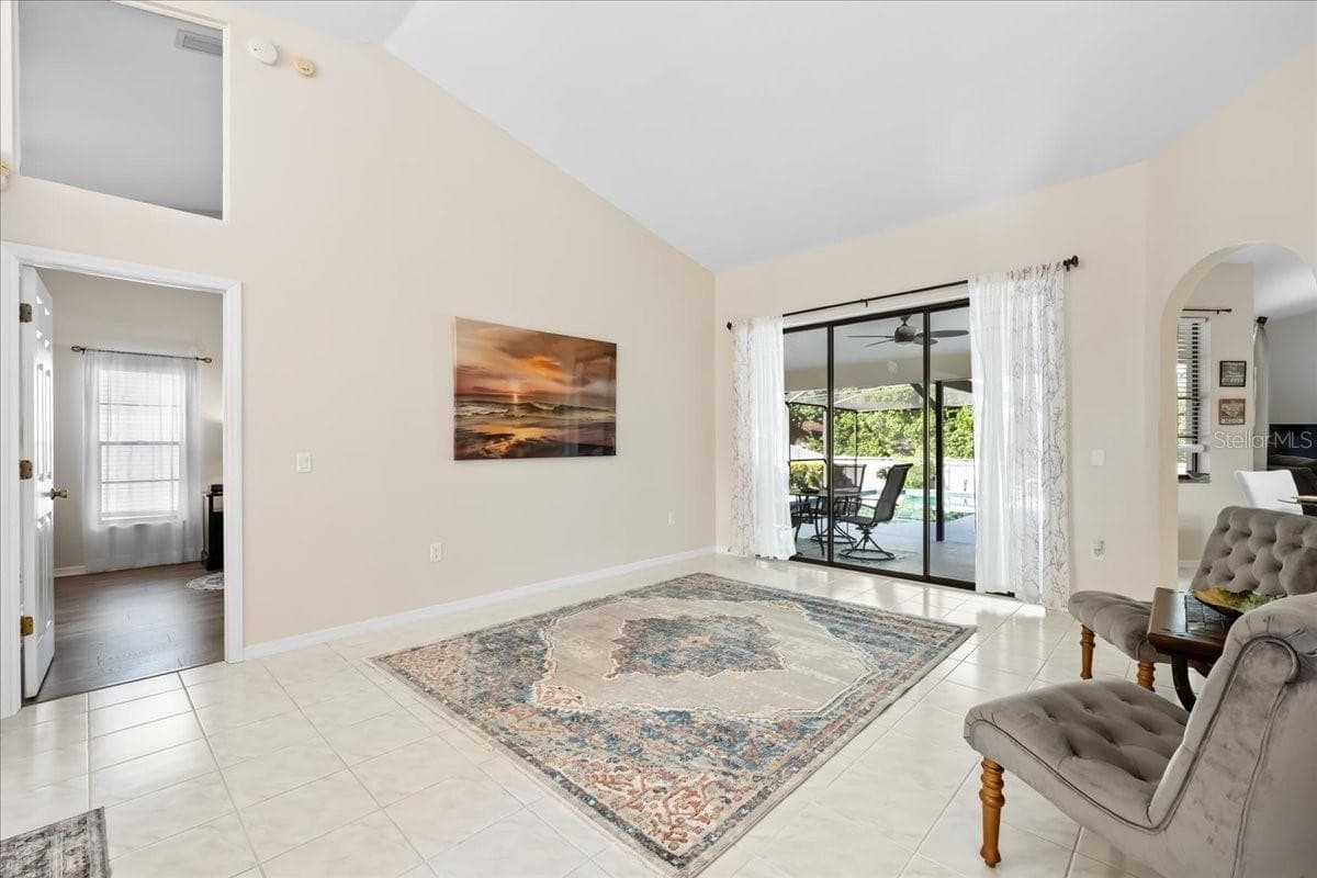 Living Room with Porch and Swimming Pool View - 2656 SADDLEWOOD LN, PALM HARBOR