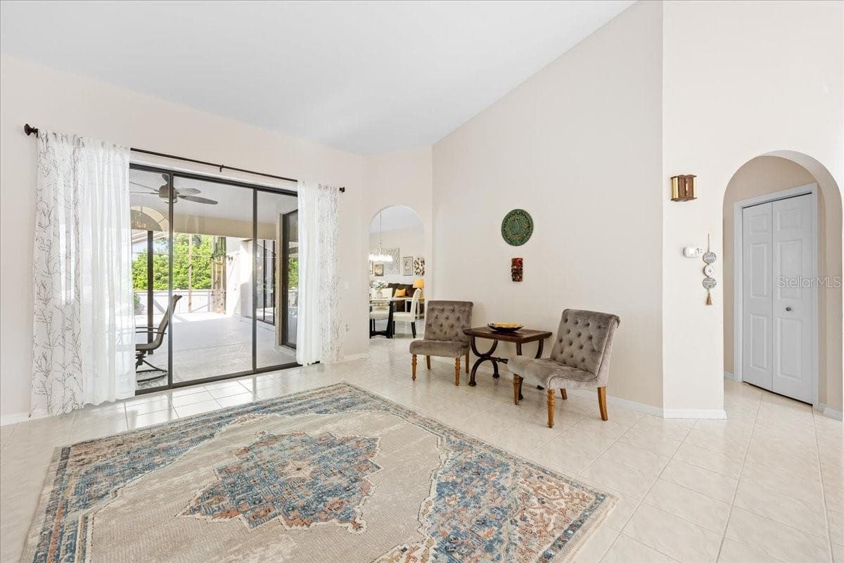 Living Room looking out to Porch and Breakfast Nook - 2656 SADDLEWOOD LN, PALM HARBOR