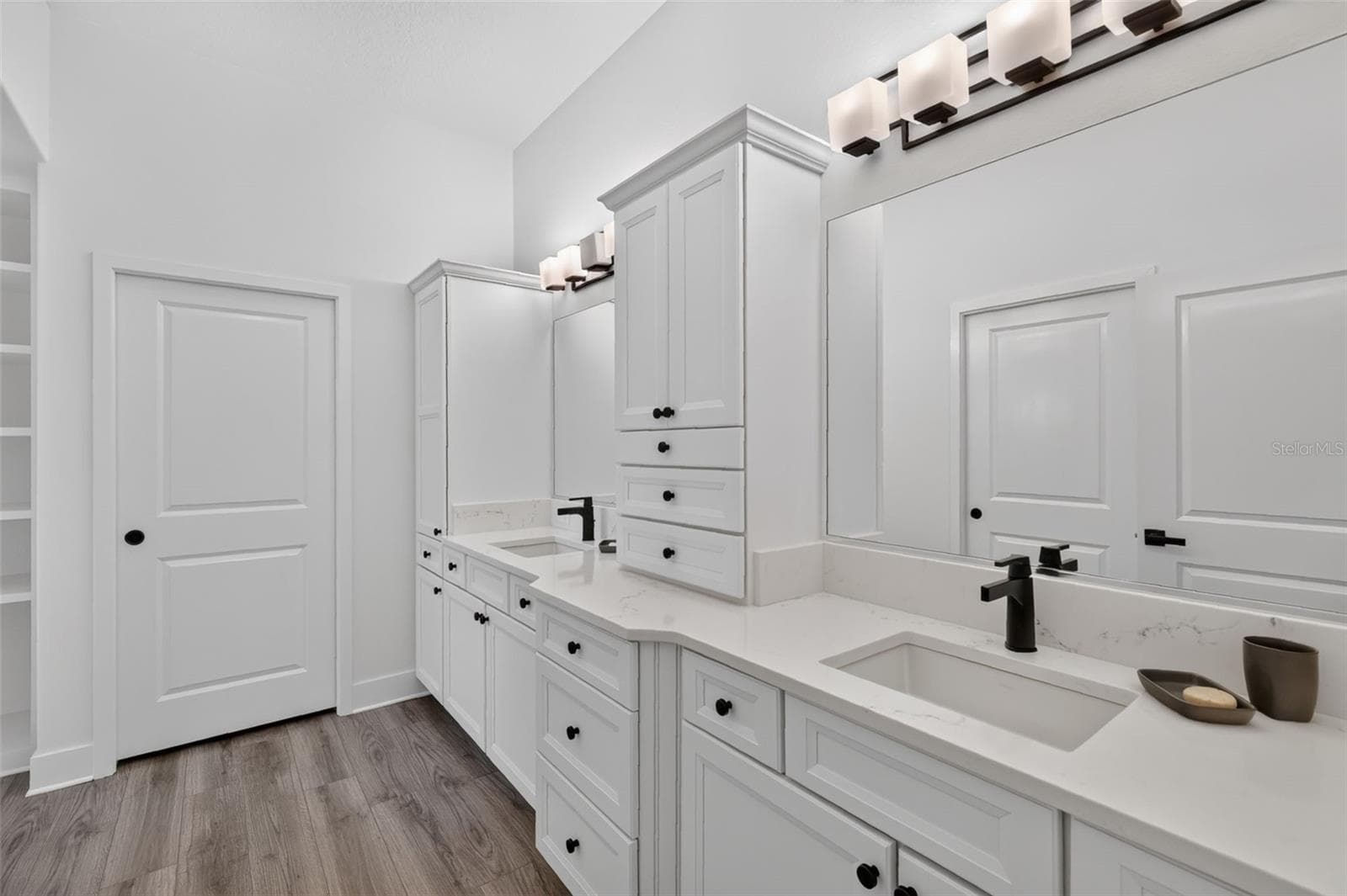 Primary bath with dual sinks and door to the water closet - 2741 DUNHAM DR, THE VILLAGES