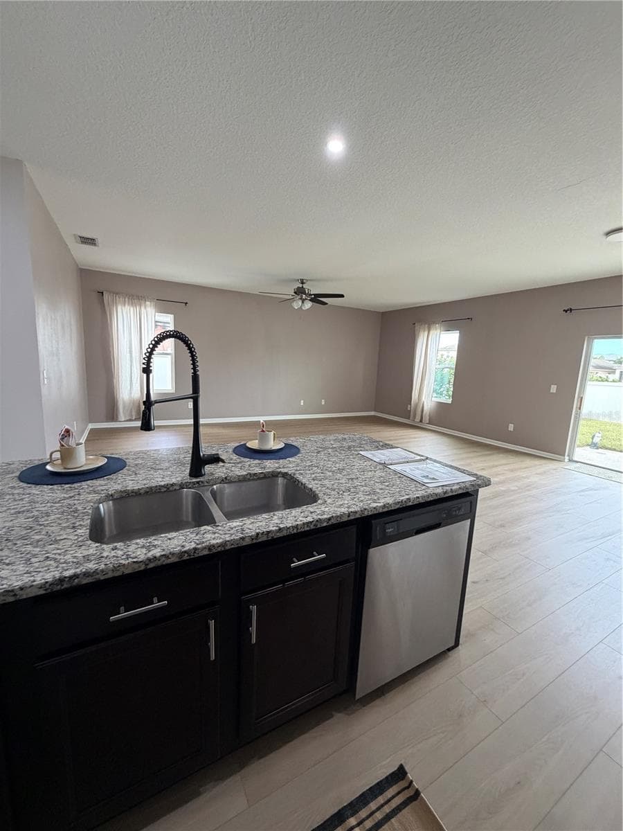 New Flooring in Large Kitchen features Oversized Granite Island Upgraded faucet and walk in pantry - 1261 ANCHOR BEND DR, RUSKIN
