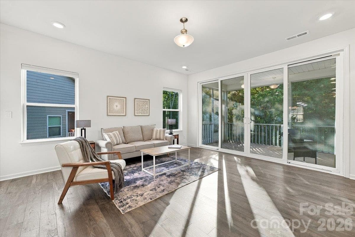 Main level living room opens to screened in porch - 24550 Blue Heron Circle, Lancaster