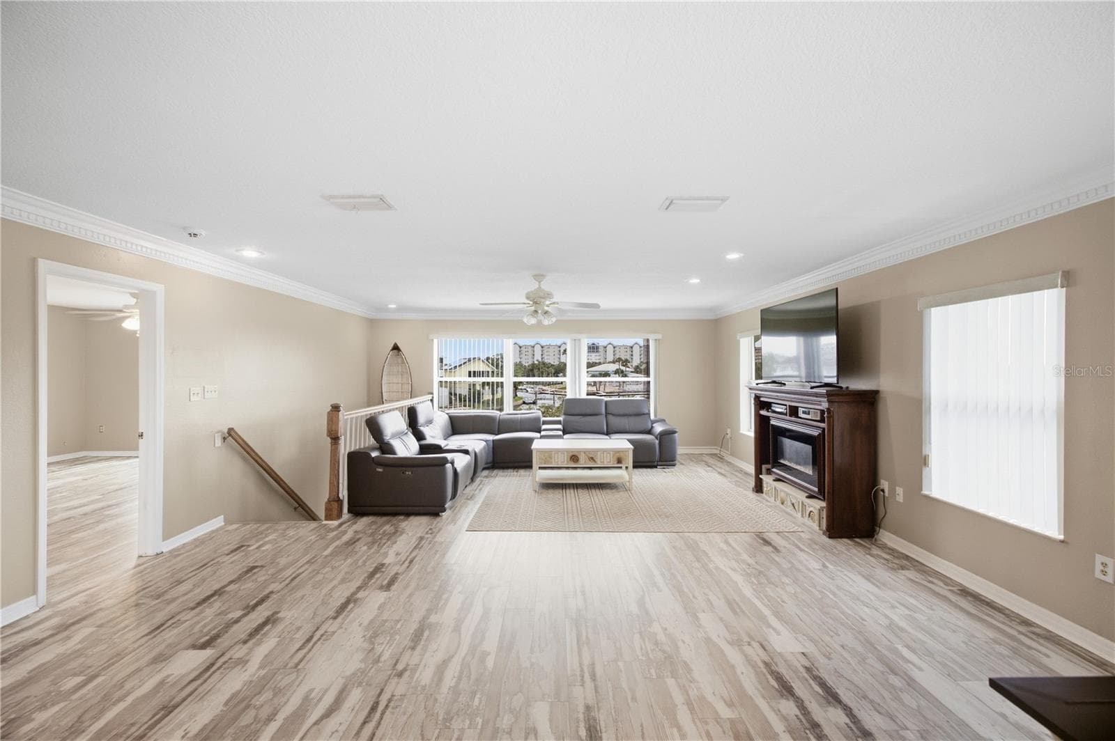 Living Room with natural light and gorgeous crown molding! - 6244 SPOONBILL DR, NEW PORT RICHEY