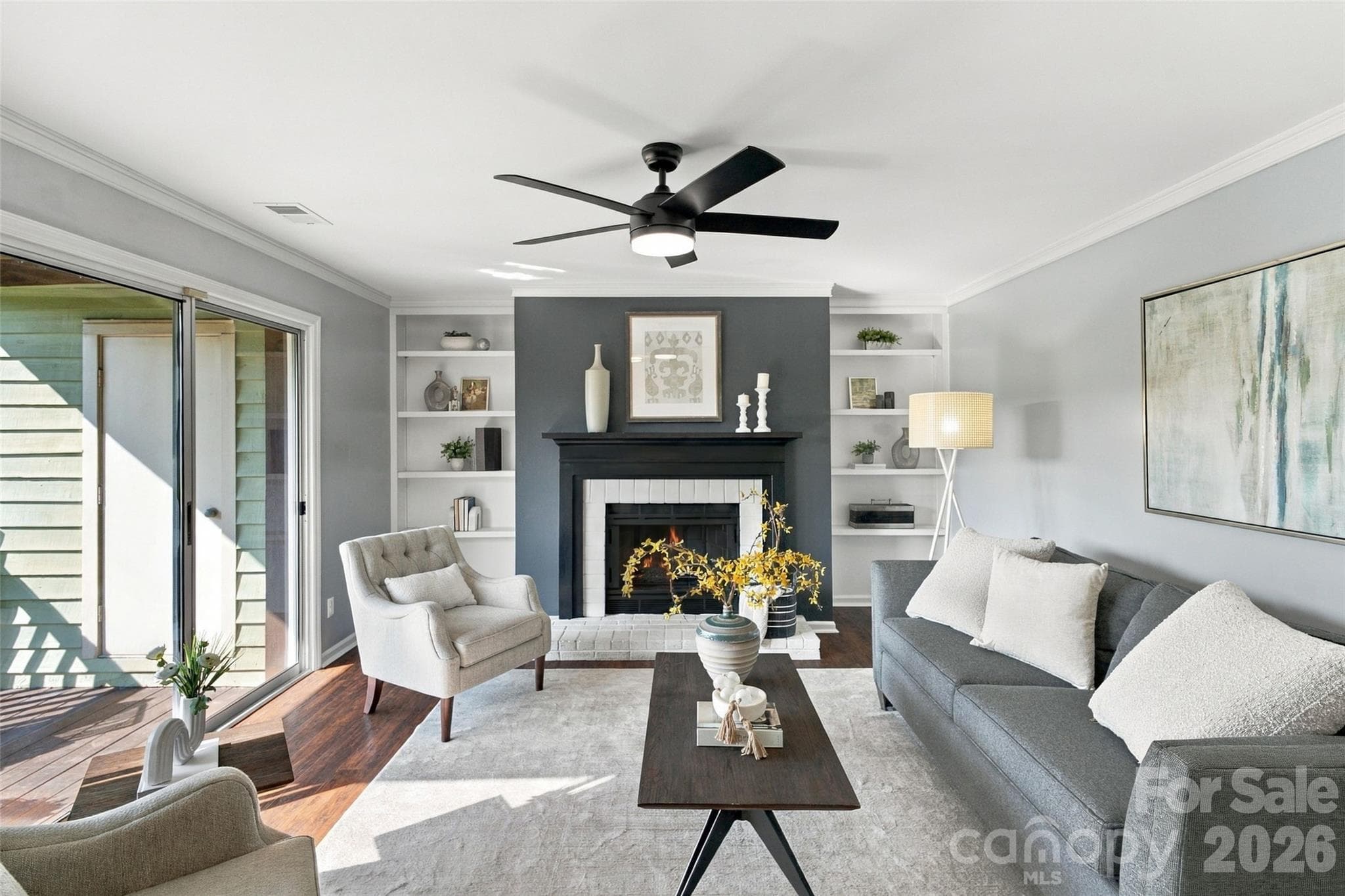 Living room with wood-burning fireplace, built-ins and access to the private balcony - 762 Marsh Road, Charlotte