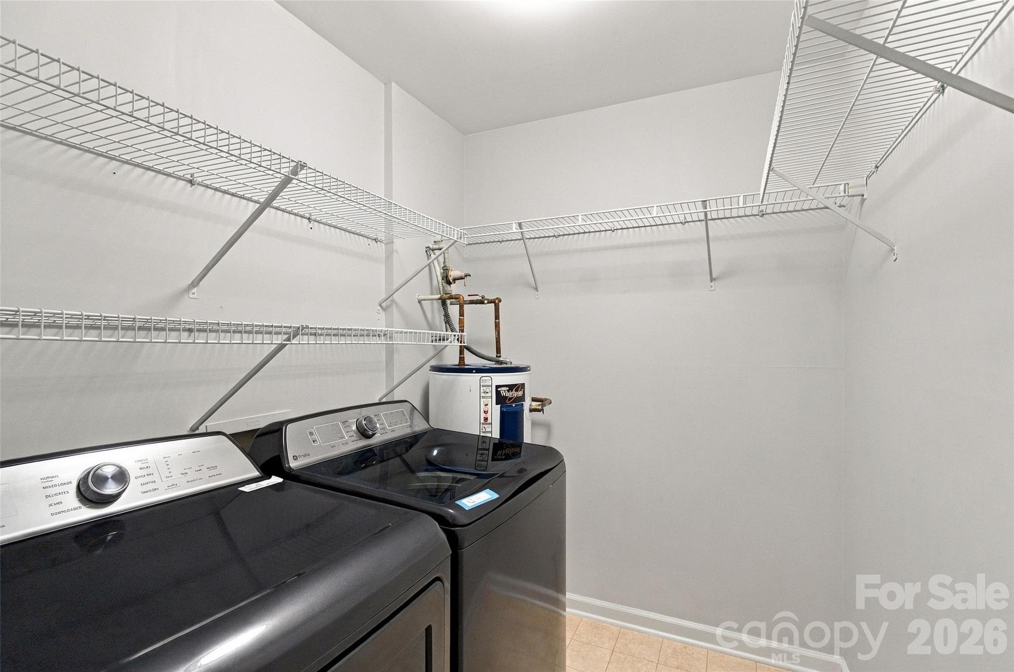 Laundry room with extensive shelving for additional storage. Washer and dryer convey. - 762 Marsh Road, Charlotte